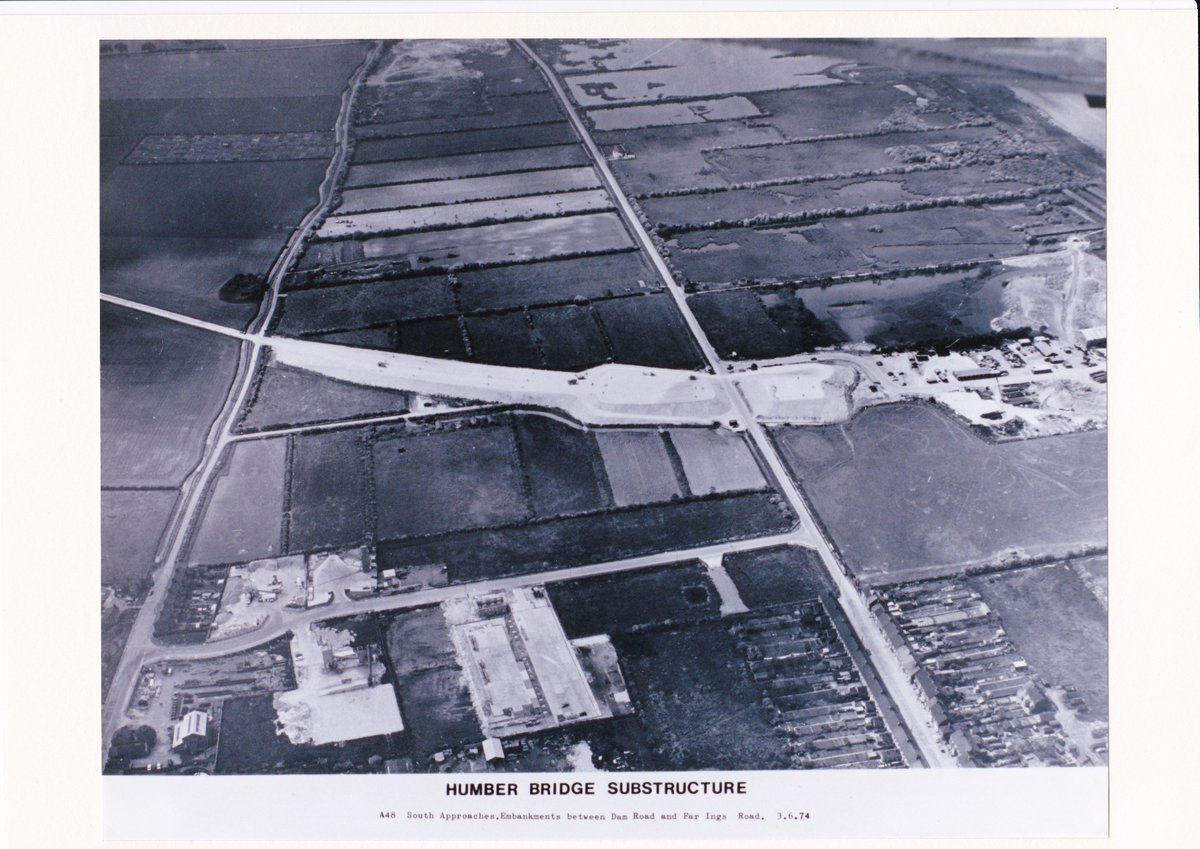 HumBridgeNews's tweet photo. On this day back in 1974, work was progressing well on both sides of the estuary. The North Tower had just reached full height, while the caissons (the concrete islands the Barton Tower sits on) were being installed. Both anchorages were also taking shape.

The joy with stunning aerials like these is looking at the surrounding areas and picking out familiar spots, such as the train line through Hessle and Far Ings Road on the South Bank.

On their radios, workers were probably listening to Sugar Baby Love by The Rubettes, which was no.1 in the UK charts. And they were possibly looking forward to seeing The Sting or The Exorcist in the cinemas - or maybe taking the kids to see Herbie Rides Again.

#humberbridge #engineering