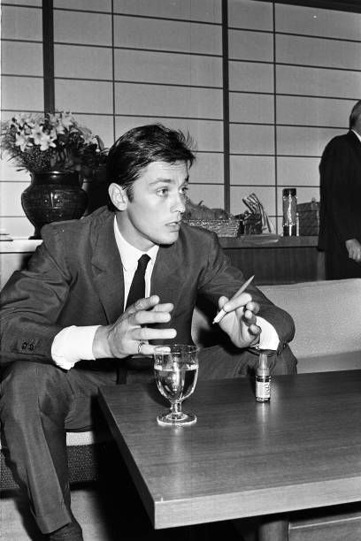 distractedfilm's tweet photo. Alain Delon, sitting there in 1960s monochrome like he’s personally invented melancholy, one hand holding a pen as if it’s a tiny disappointed philosopher, the other gesturing at the void.....

cu https://t.co/02Numna98t