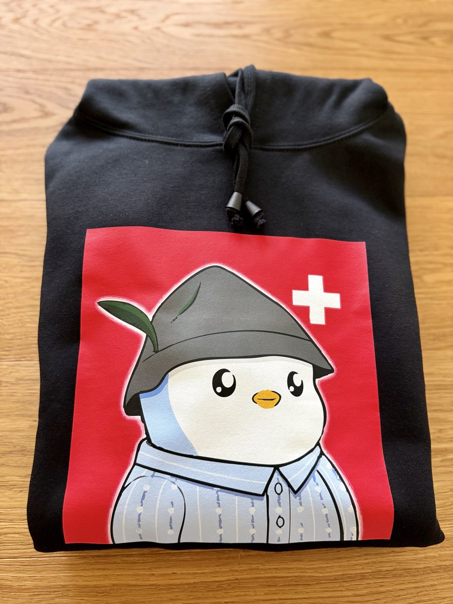 Burnasso's tweet photo. 🐧🇨🇭 Just got my @PudgySwiss Hoodie today and damn. It's insanely comfy and cozy! 😍

Super soft, pudgy AF, perfect fit, and the design? Absolute fire! 🔥

If you want to rep the cutest Swiss brand in the game, you NEED this Swiss quality merch. 
https://t.co/D05xUrz8O5 https://t.co/L7Z1FW7t5p