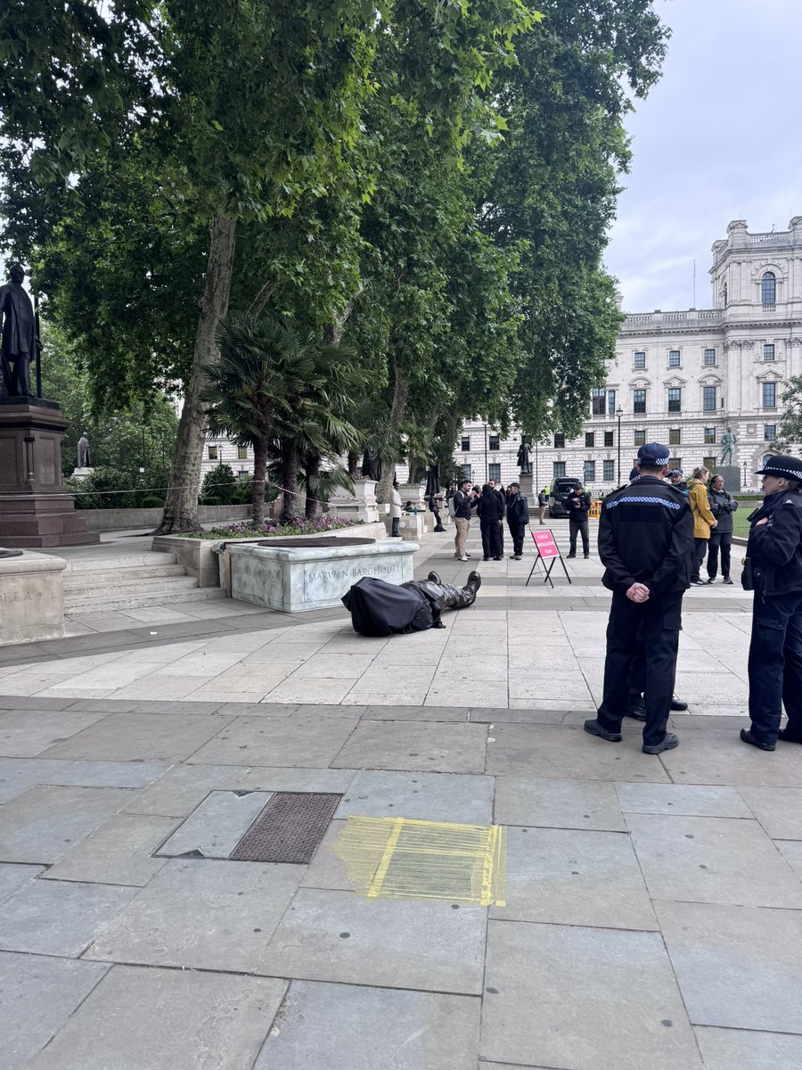 TBorwick's tweet photo. The political statue looks like it might become quite the thing. Creating a Marwan Barghouti statue falling over London Parliament Square is part of a series of protest statues. Inspired by the Banksy Flag walker? https://t.co/0xZocKYPNv
