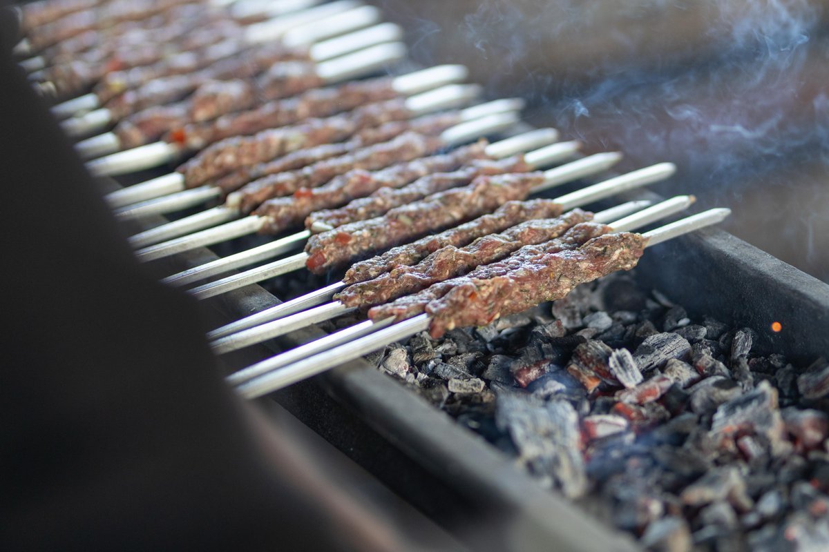 WCKitchen's tweet photo. In Gaza, keeping beloved traditions alive has become more difficult than ever—but WCK is finding a way. At the Azem Community Kitchen in Mawasi, we prepared a special Eid al-Adha meal of kebabs cooked over charcoal for children in the community. Honoring these joyful traditions helps families hold onto a sense of normalcy in the midst of so much uncertainty. Teams at WCK kitchens across Gaza work to find ways to bring moments of celebration, happiness, and hope like this to their neighbors every day. #ChefsForGaza