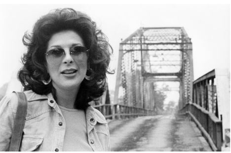 CaptLowry's tweet photo. "IT WAS THE THIRD OF JUNE, ANOTHER SLEEPY, DUSTY, DELTA DAY"

(Part TWO)

In February of 1967, Bobbie Gentry recorded a demo tape of Ode to Billie Joe, at Whitney Recording Studio in Glendale California. She sat on a stool, by herself in the studio, and she plucked it out on her guitar as she sang it. That demo tape was taken to Capitol Records in Los Angeles, and the loved it! The demo became the master tape. But Capitol still thought it needed a little something. A few days later, with Bobbie Gentry present, a producer added the strings. There is a report that when Gentry heard the finished song, she said that her song had been ruined!

There is also a story that the song was originally longer, at seven minutes. The radio version runs a bit over 4 minutes. Gentry's hand written lyrics are in the Ole Miss Archives today. They do show more verses than were recorded. The original demo tape has been searched for, and it has never been found. If ONLY???

Ode was released on July 10, 1967, as a single. It took just six weeks to hit number ONE on several charts. It landed Gentry on every television variety and talk show in America. She was an "overnight" sensation.

She went right back into the studio and cut a full album, of mostly her songs, to support the hit single. In less than a year she cut a second album. In 1968, the BBC gave her a 30 minute, weekly television show. Most of these shows can be found on YouTube today. They are interesting to say the least. After all this, she toured, she was still a guest on many shows, and she appeared in Vegas.

In the early 1970's, Max Baer/Jethro Bodine wrote and produced a movie called, Macon County Line. He wanted a song for it. He asked Gentry to write and perform that song. She did, and Baer used it for the closing credits. While working with Gentry, Max asked her about making Ode to Billie Joe into a movie. She agreed to that.

Baer tried writing three different scripts for the Ode movie, none of them worked. He finally hired the man who wrote the script for, Summer of '42. That man delivered a terrible script, but Baer went along with it. (Go watch the Ode movie for yourself) The movie was released June 3, 1976. It did well largely because of the advertising campaign. "What the song did not tell you, the movie will". Not really, but enough tickets were sold to make way more cash back than it cost to produce.

Gentry went back to appearing in Vegas with her own music show. She had already married and divorced Mr. Bill Harrah of hotel fame. He was much older than she was, and the marriage lasted less than a year. She then later married Jim Stafford of, "I Don't Like Spiders and Snakes" song fame. (Go find it on YouTube) That marriage only lasted a few years.

The Tallahatchie Bridge Gentry wrote about was the bridge that she remembered in Greenwood when she was in grade school there. It was an old steel truss bridge. After she left for California at age 13, that bridge was torn out, and replaced with a modern, flat, concrete bridge.

When the song came out in 1967, and she need a bridge to be photographed on, she took people to the old steel truss bridge over the Tallahatchie 14 miles North of Greenwood, at Money, Mississippi. That bridge washed out in 1972.

When the Ode movie was made in 1975 - 1976, she needed another old, steel truss bridge for the movie, and for her to be photographed at. She took them to the next standing bridge over the Tallahatchie, a few miles South of Greenwood.

In 1967, when Gentry was asked where the Choctaw Ridge was, she said it was the ridge East of Greenwood, that she could see from her daddy's farm when she was growing up. She said that is what they called the ridge that helps to form the Delta on the East side. Most Delta locals do NOT call the Ridge by that name.

By 1983, Gentry totally retired from show business and even from giving interview. She lives today on the Eastern outskirts of Memphis, on a large, gated estate. Good for her! The locals say she is sometimes spotted in the local grocery store.

Gentry has never answered the question of what was thrown off the bridge. 

Come back Bobbie Gentry! Somewhere in my head, I am still that nine year old boy in the Summer of 1967, hearing your song for the first time, and I am still in love with you.