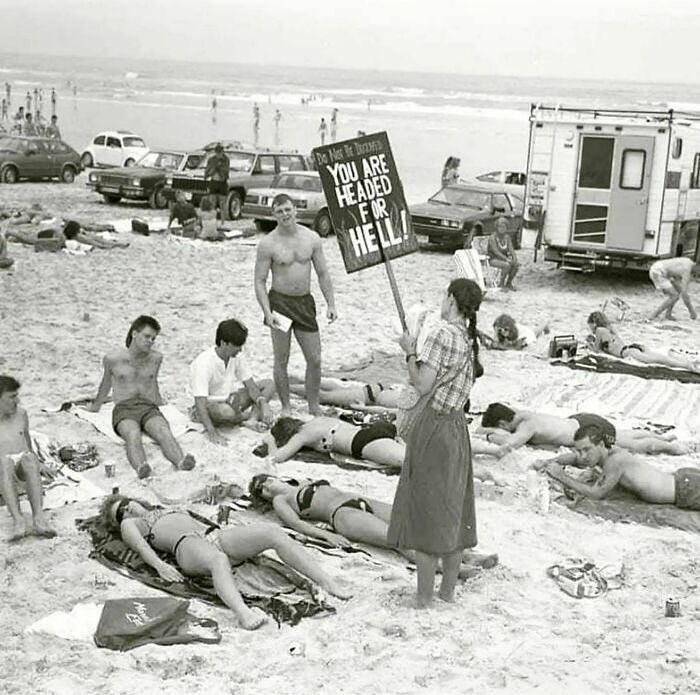 traxstarrr's tweet photo. A woman protests against the wearing of bikinis, holding a sign that reads "You are headed for hell" in Daytona Beach, Florida, 1981. https://t.co/UilLLfJQGF