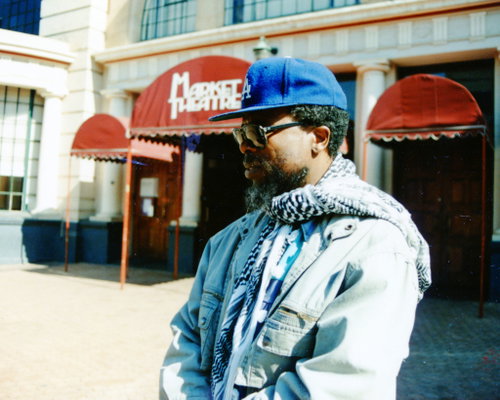 HistorySAZAR's tweet photo. John Kani outside the Market Theatre, c 1990. Credit: Peter Davis/Villon Archives https://t.co/u5k1u6D1oi