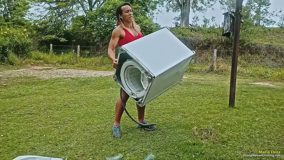 CrushingWoman's tweet photo. Maria Luiza flexes her massive biceps, hoists a washing machine and CRUSHES it into scrap with pure muscle power! 💪  
Watch the full destruction: https://t.co/Vl4kYBjQuA  
#StrongWoman #MusclePower #FeatsOfStrength https://t.co/l40ehGYCzp