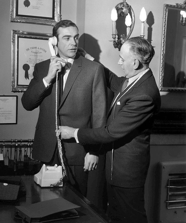 ithacarising's tweet photo. Bond has taste. He is a dream character for most men. Wouldn't everyone like to have the birds fighting over them, and be able to tell a bartender how to make cocktails?
- Anthony Sinclair

Anthony Sinclair was the tailor who defined James Bond’s iconic look. He dressed Sean Connery in the first five 007 films: Dr. No, From Russia with Love, Goldfinger (including the legendary three-piece suit), You Only Live Twice, and Diamonds Are Forever.

It was director Terence Young who brought in his own Savile Row tailor, Anthony Sinclair, to transform the rough, working-class Connery into the sleek, sophisticated gentleman spy we know today. For the shirts and ties, they turned to Young's personal shirtmaker, Turnbull & Asser, who created Bond's signature double-cuffed shirts.

Connery wasn't used to wearing suits, so Young made him live in them - reportedly even sleeping in the tailored outfits - to ensure that by the time filming began, the clothes felt completely natural. The transformation was total.
