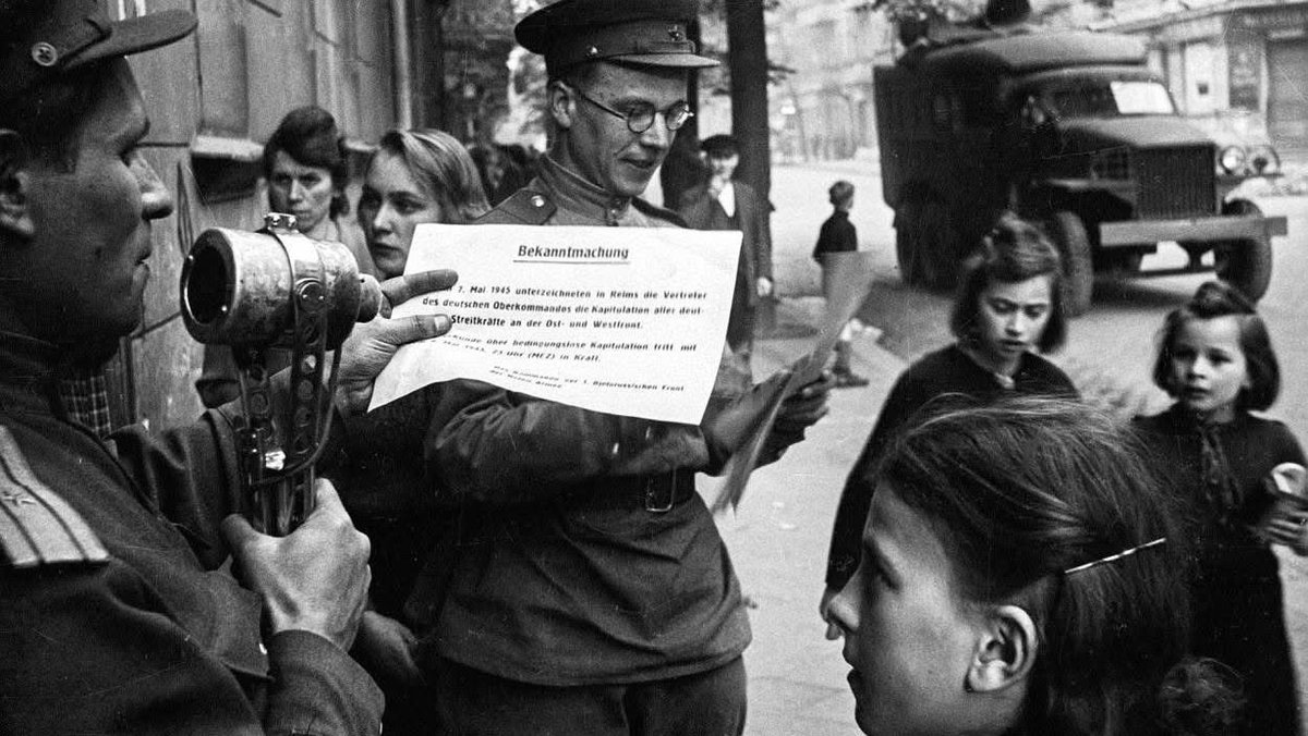 VoicesofWW2's tweet photo. "...making Berlin a city inhabited exclusively by women, children, and the elderly."

Berlin, the May 1945 census.

The census initiated by the Soviet military administration in May 1945 was not a simple collection of statistical data, but a vitally important emergency military security and social control operation.
Counting the population in a destroyed city like Berlin was the only way to avoid total collapse.
In a city where there was no food and the black market was rampant, the census served to calculate how many mouths needed to be fed and to distribute new food stamps based on work categories; those who didn't register didn't eat.
Furthermore, given that thousands of Wehrmacht soldiers, SS members, and Nazi Party officials had removed their uniforms to blend in with the civilians, the census required everyone to declare their identity, current address, and last job, thus allowing Soviet counterintelligence (SMERSH) to cross-reference the data and track down any fugitives.
Last but not least, the city was paralyzed by 75 million cubic meters of rubble. 
Registering the population meant counting the available workforce (especially women) to be conscripted for forced labor, clearing streets and reactivating services.
The data revealed that Berlin had effectively become a "City of Women and the Elderly."
The first practical results of the census in those weeks revealed a shocking demographic reality, later formalized in subsequent official counts in the summer of 1945.
From 4.3 million inhabitants in 1939, only 2.8 million people remained in Berlin. 
One and a half million citizens had vanished into thin air through evacuations, escapes, deportations, and deaths.
The most striking finding was the catastrophic imbalance between men and women. 
In the 20- to 40-year-old age group, men were almost nonexistent (killed at the front or still held in Soviet and Allied prison camps). 
In practice, the census showed that there were approximately 1,700 women for every 1,000 men in the city, effectively making Berlin a city inhabited exclusively by women, children, and the elderly.
In that climate of chaos and fear, the Soviets exploited the few remaining municipal officials and building managers (Hausvertrauensleute). Citizens were required to report to temporary registration centers set up in neighborhoods or fill out forms distributed in apartment buildings.
Giving false statements or attempting to hide carried the risk of being shot on the spot as spies or collaborators, or immediate deportation to labor camps in Siberia.
For Berliners, lining up to be registered by the Soviet victors was the first step—humiliating, yes, but inevitable—to begin living legally again and earning the daily bread they needed to survive.

All the images in the post are part of the series of photos taken by Valery Faminsky.