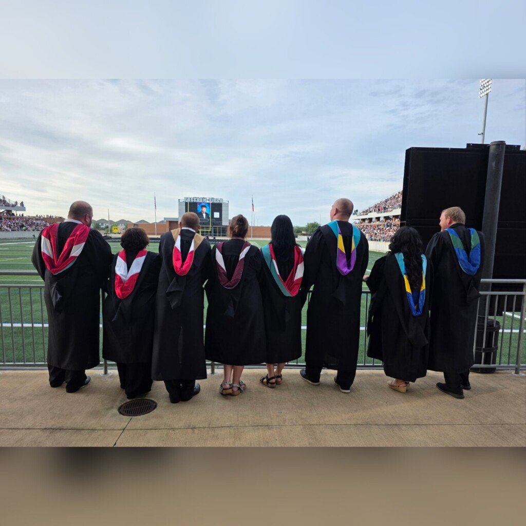 AlvinHSJackets's tweet photo. Before the cheers, before the diplomas, before the tassels turned—eight administrators pause for a final look across the field, reflecting on the journey that brought the Class of 2026 to this moment.

Congratulations class of 2026. https://t.co/7TnhlqUirE