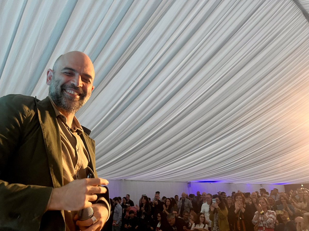 sallyhayd's tweet photo. Full house &amp; standing ovation for @robertosaviano in Dublin tonight at @ILFDublin. 
His new book is ‘Shout it Out: 28 Portraits for a Committed World’ https://t.co/LxMpEfNjD3 https://t.co/yjfD5ptYWO