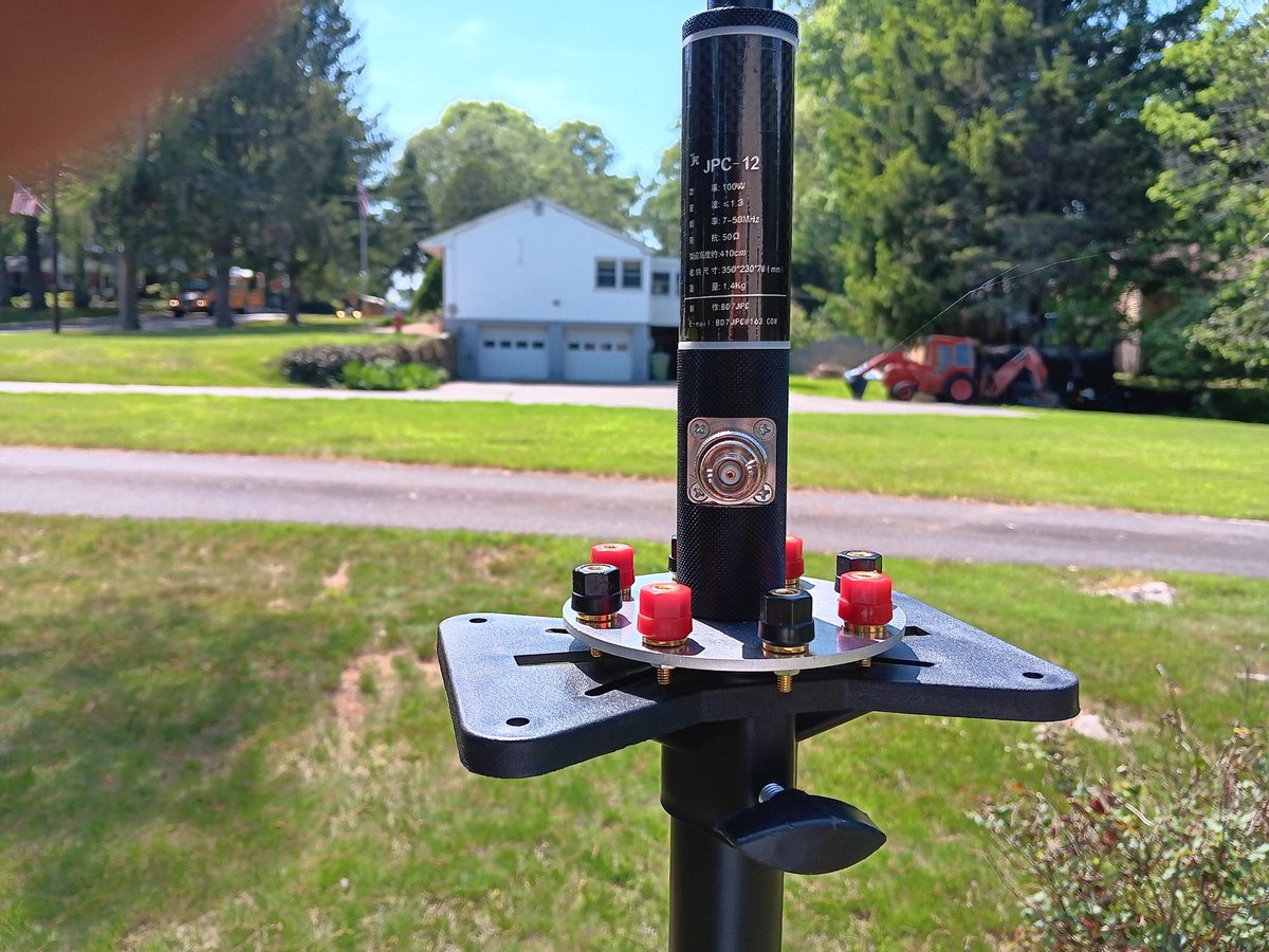 K3TripleR's tweet photo. Ross Johnson: "I found this great 5Core 48” DJ speaker stand tripod on ebay to use with my JPC-12 antenna. For $21 including shipping and tax, the light gauge steel tubing (about 5lbs total) is quite stable and durable. Yes, some of the parts are plastic and probably would not stand up to a 50mph dive off the back of a pickup, but it seems pretty capable of delivering good service as an affordable field stand… folds down to about 28”, extends to 54”.

I had to drill a hole in the provided top plate to run a 10mm bolt up through my counterpoise disk and into the antenna base, but that was the extent of the mod’s. I set it up with my G90 in the backyard and added 4 counterpoise wires out to tent stakes. It was a quick stable setup and the 10-15mph wind had no effect at all.

The best QSO of the day with stand fulling extended was well over 1300mi… Connecticut to Kansas, 5-9 on 20 watts. It will definitely have a home in the POTA activation kit stored in my pickup."