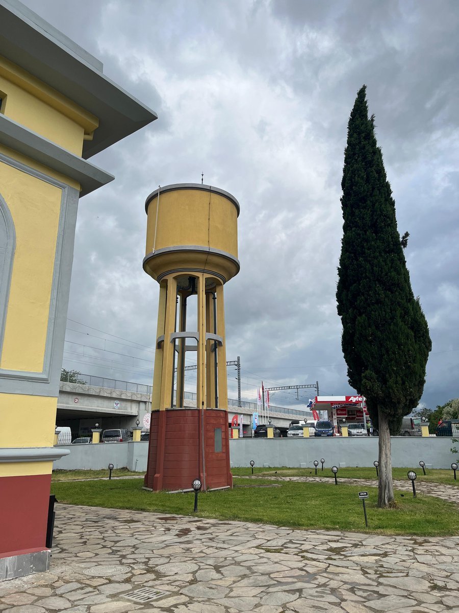 EvergreenDazed's tweet photo. A water tower outside the Old Electricity Factory, shown here next to Bernd and Hilla Becher’s Water Towers (1988).

This connection feels especially meaningful in the context of Hypertopographics. The title of the series refers partly to the New Topographics movement, crystallized by the landmark 1975 exhibition New Topographics: Photographs of a Man-Altered Landscape. The Bechers were among the defining figures of that shift: They photographed industrial structures, water towers, blast furnaces, gas tanks, and mineheads with a rigorous, frontal, typological method, treating anonymous infrastructures as subjects worthy of sustained visual attention.

Their influence on contemporary photography is enormous. Through Bernd Becher’s teaching at the Kunstakademie Düsseldorf, their approach helped shape what became known as the Düsseldorf School of Photography, influencing artists such as Andreas Gursky, Thomas Ruff, Candida Höfer, and Thomas Struth.

Their systematic approach to photography has been one of the foundations of my artistic thinking.

In that sense, encountering this tower at the exhibition site is not just a visual coincidence. Hypertopographics grows out of that historical lineage but pushes it into another condition: From the clear typologies of industrial modernity toward the overwhelming, layered, hyperconnected systems of the present. The “hyper” in Hypertopographics brings Timothy Morton’s idea of hyperobjects into dialogue with New Topographics: systems so vast, distributed, and entangled that they can no longer be grasped from a single viewpoint.