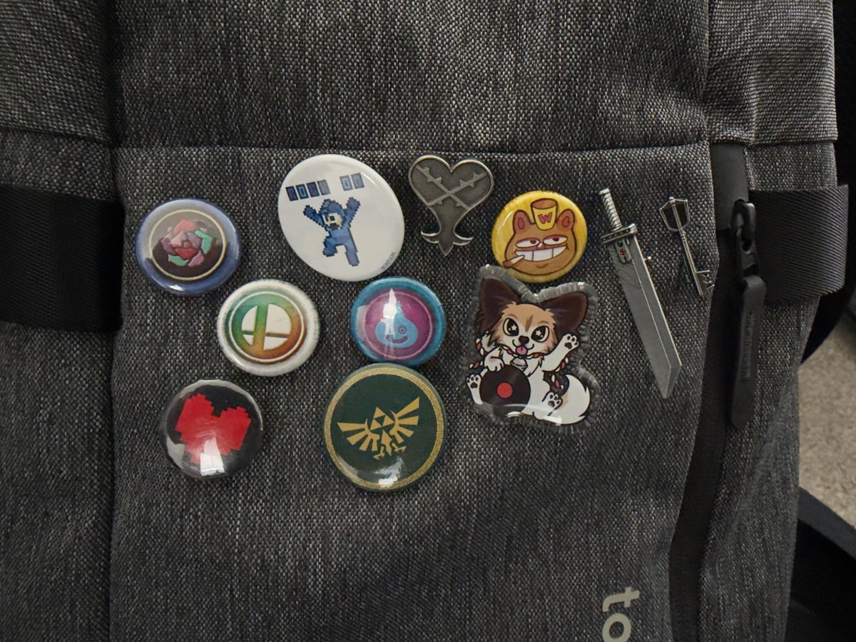 TravisTubbs's tweet photo. Have to start going into the new company office tomorrow, meaning I'm carrying around a backpack. Age be damned, this backpack is gonna get buttons galore! It's like I'm in school all over again. (Except I don't think I actually decorated my backpack then...) https://t.co/11fE9D5Rj7