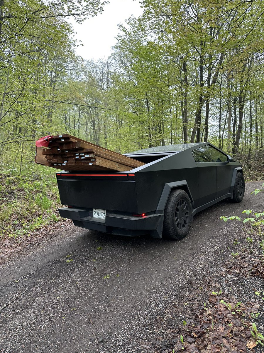 Yev_K's tweet photo. Another day working hard for a cybertruck yet it looks like it’s barely working with this another load of wood 🪵 Self Adjustable air suspension is incredible, considering I am in a steep hill 👌 https://t.co/cxVBcsj2Km