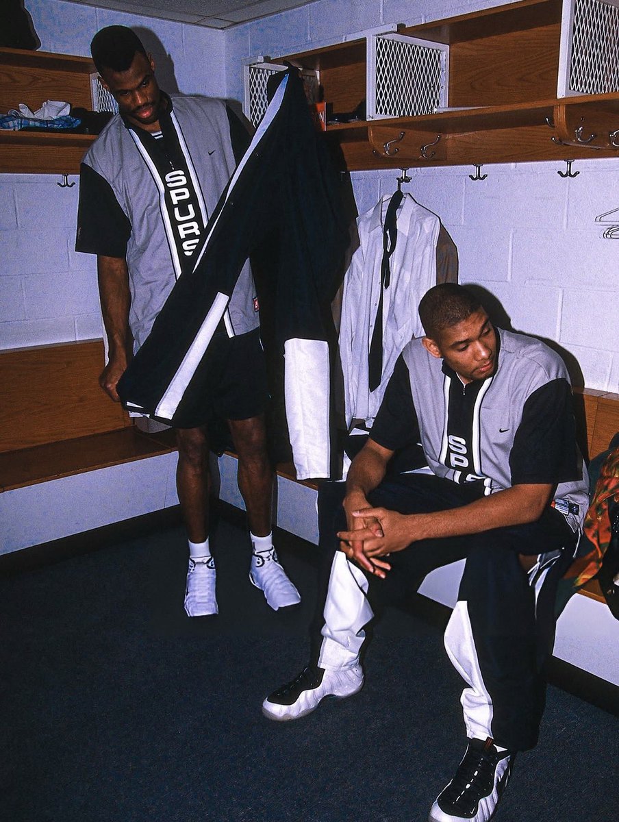 TheNBAArchive's tweet photo. David Dobinson and Tim Duncan sitting in the locker room prior to the All-Star game. (1998) https://t.co/j5LDjx88sg