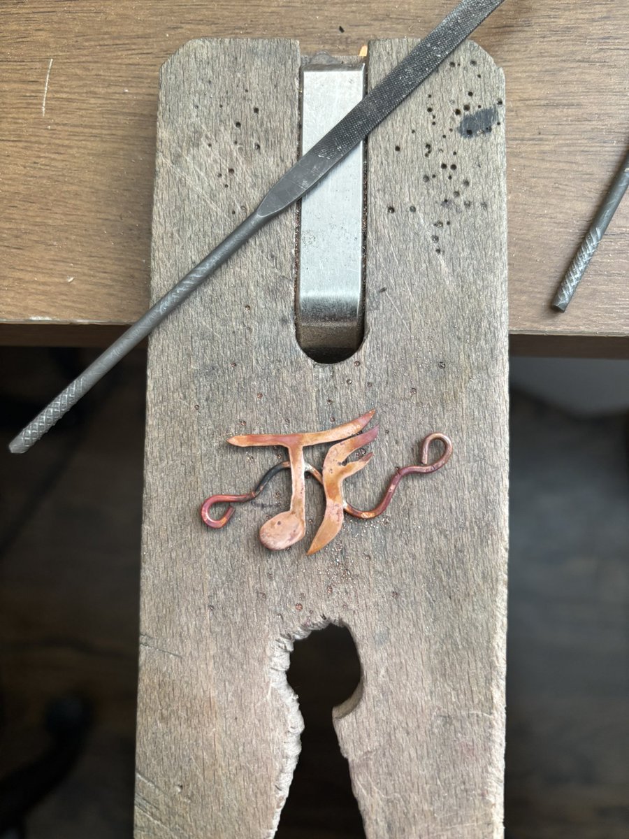 ghostiemeow's tweet photo. i am so beyond excited for the tfo debut that i smithed a pendant of their logo 😂
here it is hot off the soldering block &amp; then also all polished up ✨

#TleFirstOneDuoDebut https://t.co/2xnlio22OA