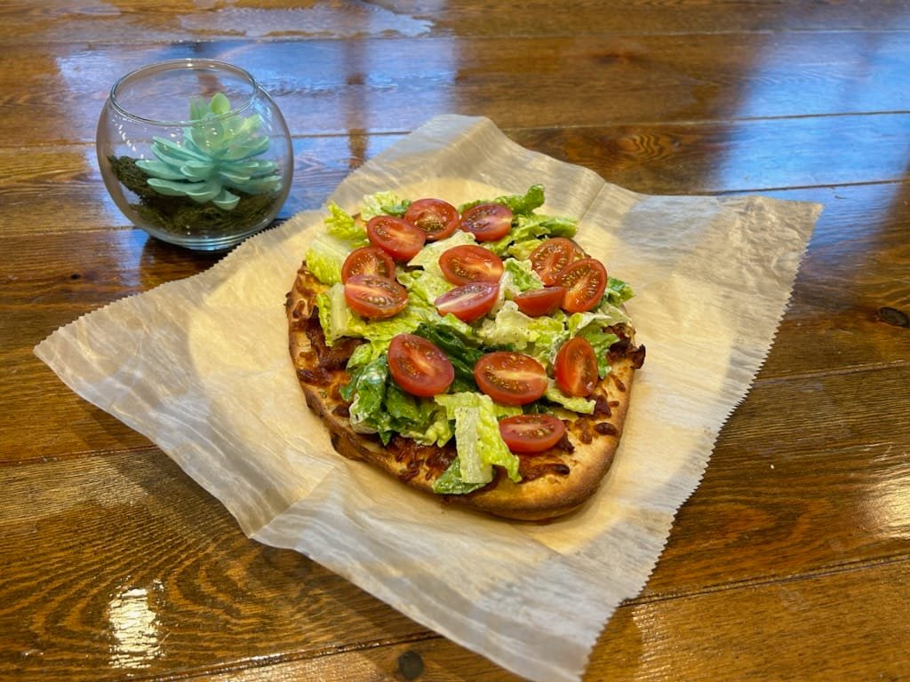 Riverfrontbc's tweet photo. Warm naan bread topped with herb cream cheese, mozzarella, and Boursin, baked to golden perfection. Finished with crisp romaine lettuce, smoky bacon, herb mayo, and fresh grape tomatoes.
Come grab one while it’s hot! 🔥 https://t.co/WxcIV6bz27