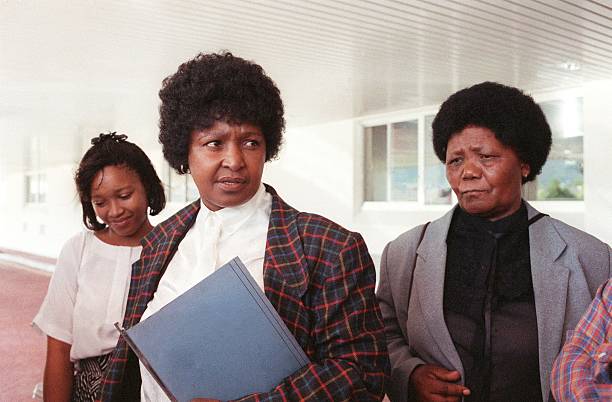 HistorySAZAR's tweet photo. Winnie Mandela (c), with her daughter Zinzi (l) and Lieby Piliso, Nelson Mandela's sister, speak to journalists, October 1988. Credit: Rashid Lombard / AFP https://t.co/JZzgzM9LEL