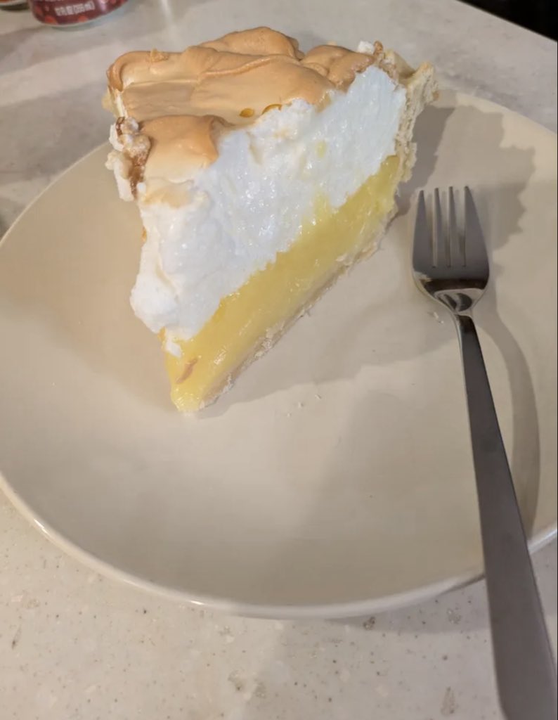 debby_bob's tweet photo. A slice of lemon meringue pie on a plate with a fork. 😋 https://t.co/teBqdBPzH6