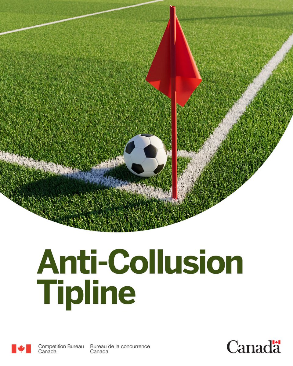 A corner view of a soccer field with a soccer ball next to a red corner flag.