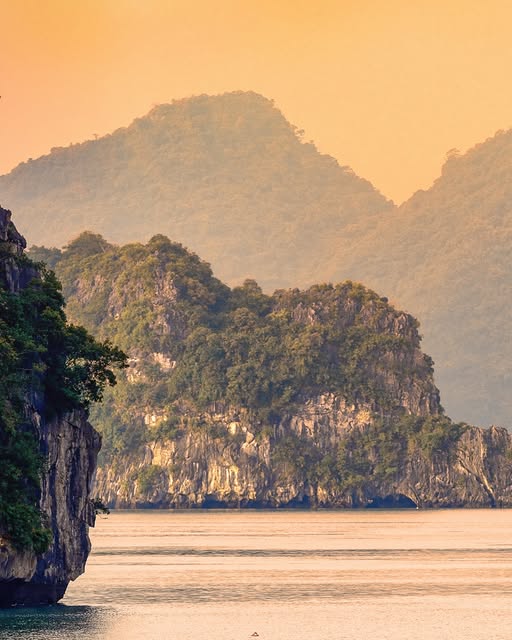 LocDang4's tweet photo. This photograph immediately evokes a sense of calm and escape. The soft golden light, layered mountains, and still water combine to form a scene that feels almost unreal. https://t.co/Fxs0RY4PKQ https://t.co/cVHd8Fn6qh