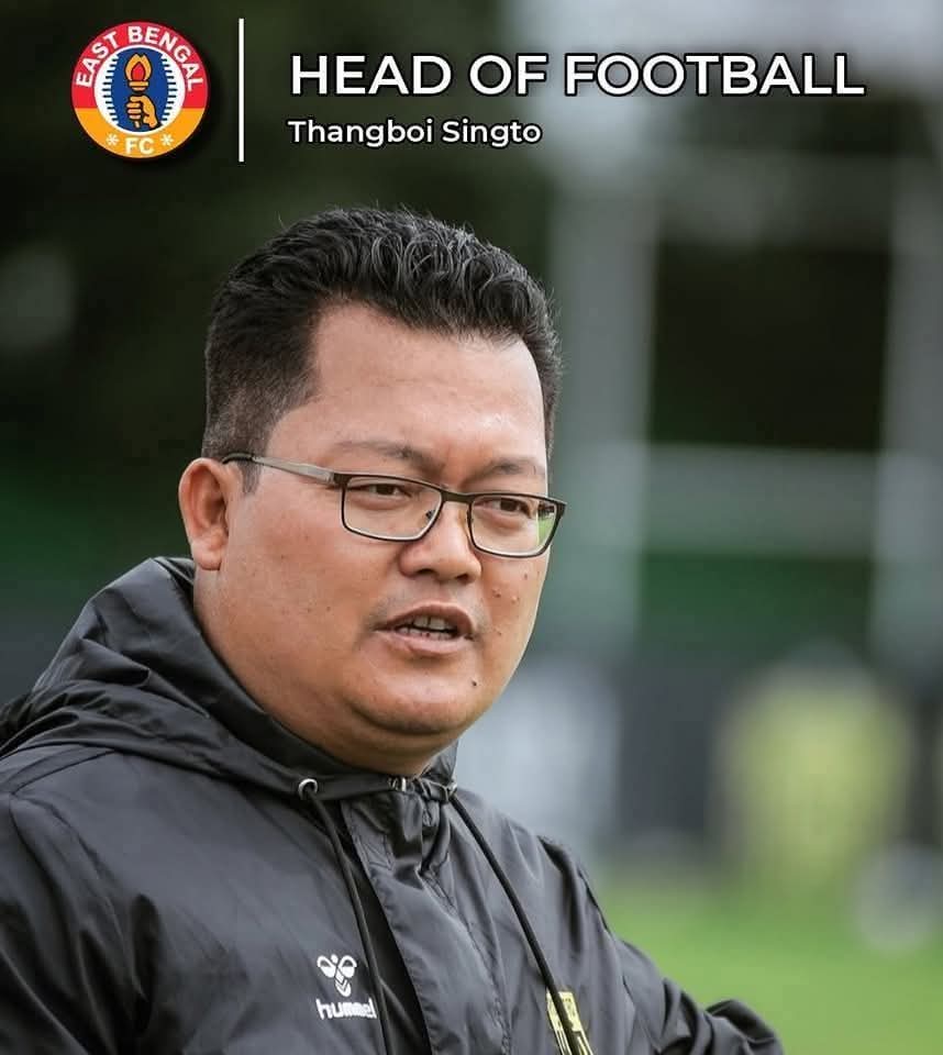 EBRPFC's tweet photo. Not every hero stands on the touchline.
Some build the foundation that champions stand on.
Thanboi Singto — the silent architect behind the resurgence of East Bengal FC.
From smart recruitment to building a stronger footballing structure, his vision, dedication, and relentless work behind the scenes played a pivotal role in bringing glory back.
No unnecessary noise or self-promotion unlike some official.
Just relentless work for the badge. 

A name every East Bengal supporter will remember with gratitude. ❤️💛🔥

#JoyEastBengal #EBRP