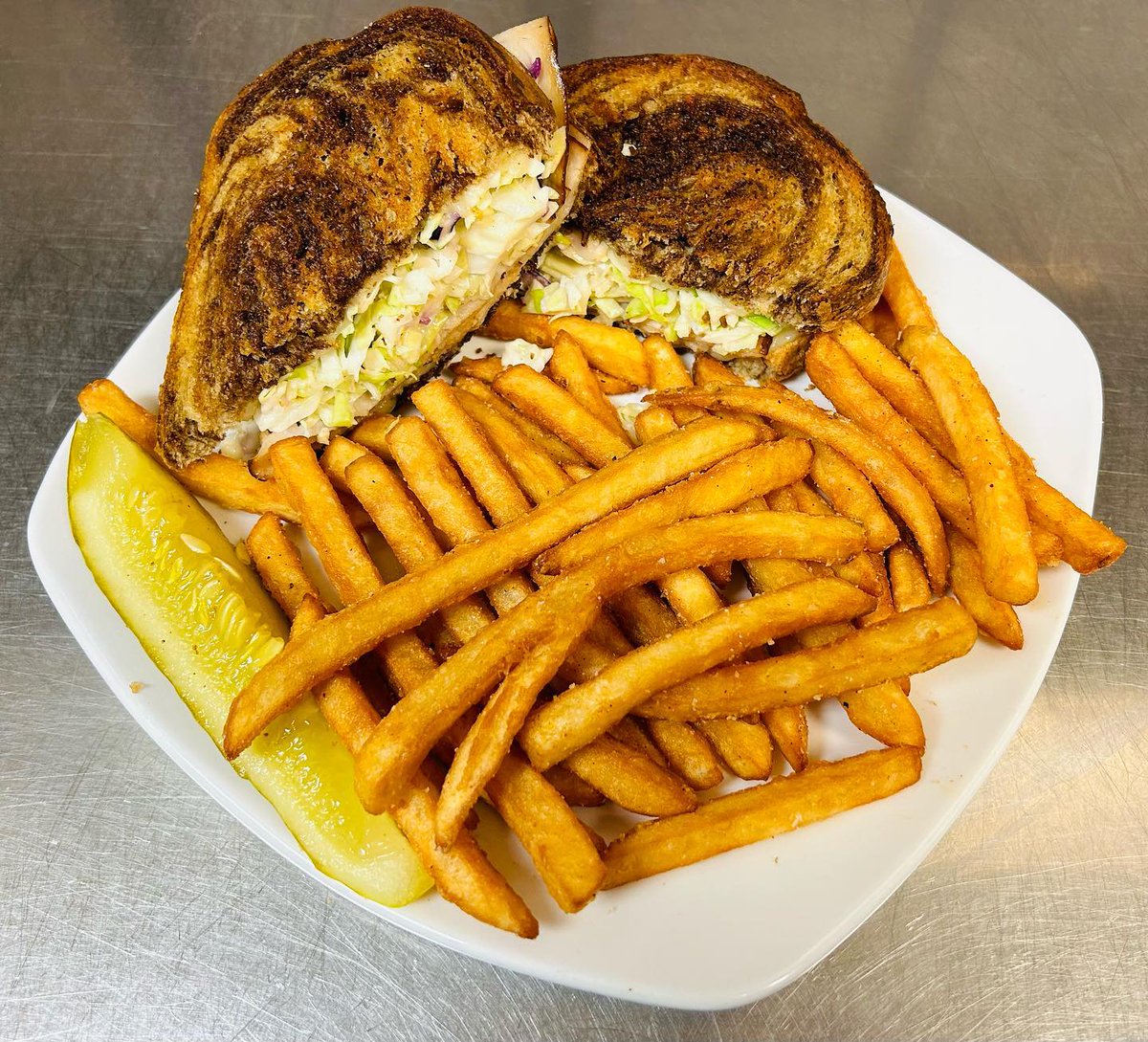 Riverfrontbc's tweet photo. Today’s lunch special: Turkey Reuben! 🥪🔥
Piled high with sliced turkey, melted Swiss cheese, and our homemade coleslaw on grilled marble rye bread. Served with crispy seasoned fries and a pickle spear.
Come grab one while it’s hot! https://t.co/2wKC7dNFFf