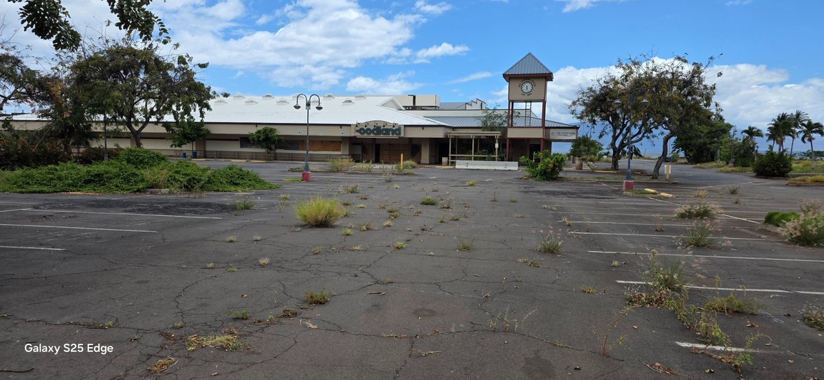 GreatBasinPower's tweet photo. 𝗦𝗼𝗺𝗲𝘁𝗵𝗶𝗻𝗴 𝗙𝗲𝗲𝗹𝘀 𝗢𝗳𝗳 𝗜𝗻 𝗠𝗮𝘂𝗶

Yesterday, I visited what remains of Old Town Lahaina, my first in-person look since the 2023 fire, and what I found struck me sideways, backwards, upside down, and inside out. A once vibrant village simply vanished as though the fire gods themselves remorselessly targeted Maui's heart and soul, transforming the island's feel into a place that might as well be the mainland.

Crumbling walkways, pier supports without piers, hollowed-out concrete structures, US Army Corp of Engineers signs, and "government property no trespassing” warnings supplant seaside restaurants, cobblestone walkways, catamaran snorkel sail, bustling shopping, and barefeet works everywhere good vibes; transforming the area into a desolate and empty shell increasingly hidden by weeds sprouting through walkway and parking lot cracks - erasing bit by bit evidence such a magical place ever existed.

Lack of restoration stuns the senses. I see no effort being made to rebuild the area save a few  apartment structures outside the perimeter of Old Lahaina. No contractors anywhere. No people except one woman who appears to own one of the shelled out buildings, sitting inside a plastic storage shed doing nothing. Three or four tourists walk around Lahaina's famed but now fenced off banyan tree, miraculously spared from the firegod's wrath. Foodland Grocery chose to rebuild outside the district rather than wait upon whatever it is being waited. Outlet stores seem to have chosen nothing rather than rebuild elsewhere.  Some enterprises, like Dukes, relocated to sprawling golf/condo Kaanapali. Otherwise, nothing.

A bypass highway skirts visitors and residents around downtown and, for those who never visited Maui pre-fire, nothing strikes them out of the ordinary. Highway speeds, impatient drivers,  near constant traffic, and small strip malls give the place a mainland feel - contradicting directly what made it uniquely special to those of us fortunate enough to visit the island in the 80s, 90s, and early 2000s. Almost immediately upon exiting Kahului Airport a giant Walmart, Target, and Home Depot retail area greets visitors.  Several random homeless people hint at a larger, hidden population which I find accidentally later, including one sizable contingent outside Paia lining a decaying road not far from architecturally profound Old Maui Highschool. 

At a distance, Maui appears the same beautiful place I fell in love with years ago. Up close, it feels increasingly like an aging oceanside, socio-economic segregated area almost akin to some areas of California except, unlike like Laguna Beach, Medicino, or even old town Napa, it lacks the unique heartbeat only old town areas can bring to a community. And, for myself, that's the problem. Maui doesn't feel like a community because what made its heartbeat beat sits idle, lifeless, seemingly forgotten. 

I don't live there nor do I own Lahaina property; therefore, I lack insight about local dynamics but of one thing I'm quite sure: something isn't right. It's plain as day. And it ruined my desire to revisit.

More photos at https://t.co/NcFoqWeoR5
