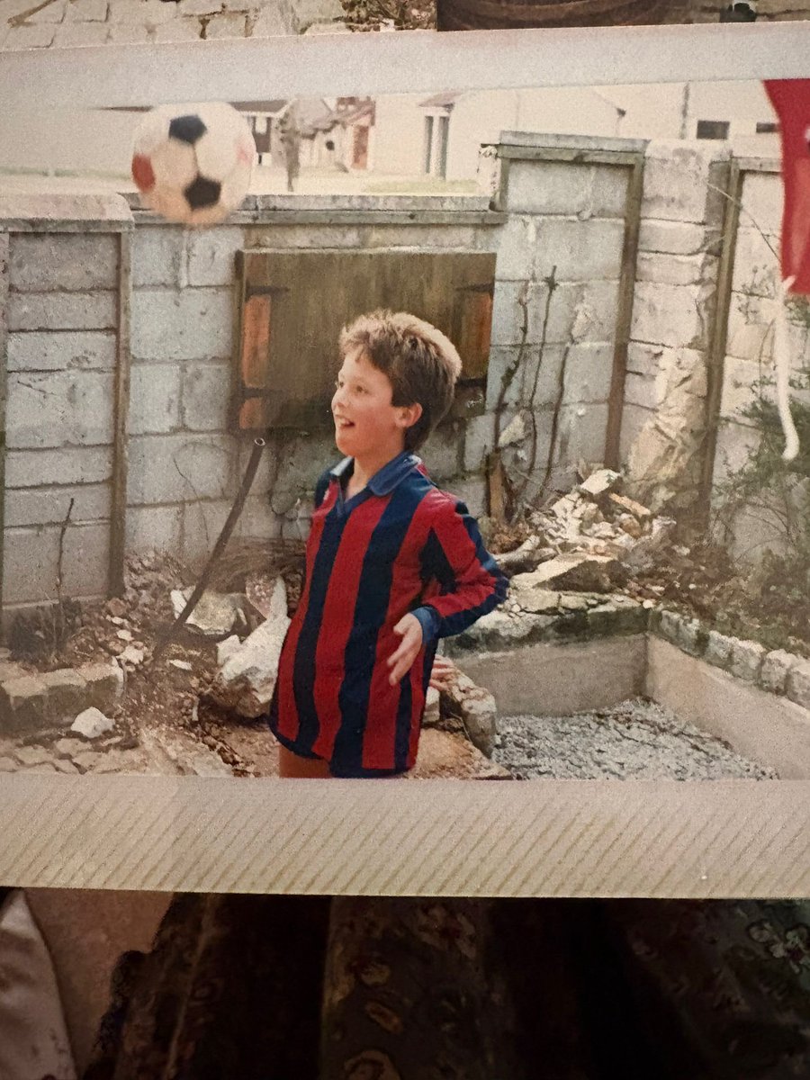 FootballInT80s's tweet photo. This photo would have been taken in 1987. I was 10.

The only way to get a “foreign” shirt in those days was for someone to actually go to that city and bring you one back.

I was lucky enough to have a Barcelona shirt brought back for me. In an age when not many kids had replica shirts, I became known as “the Barcelona kid”.

Great memories — and a great shirt too.

PS: I didn’t grow up in a war zone… I think our garden was being done up 🤣🤣