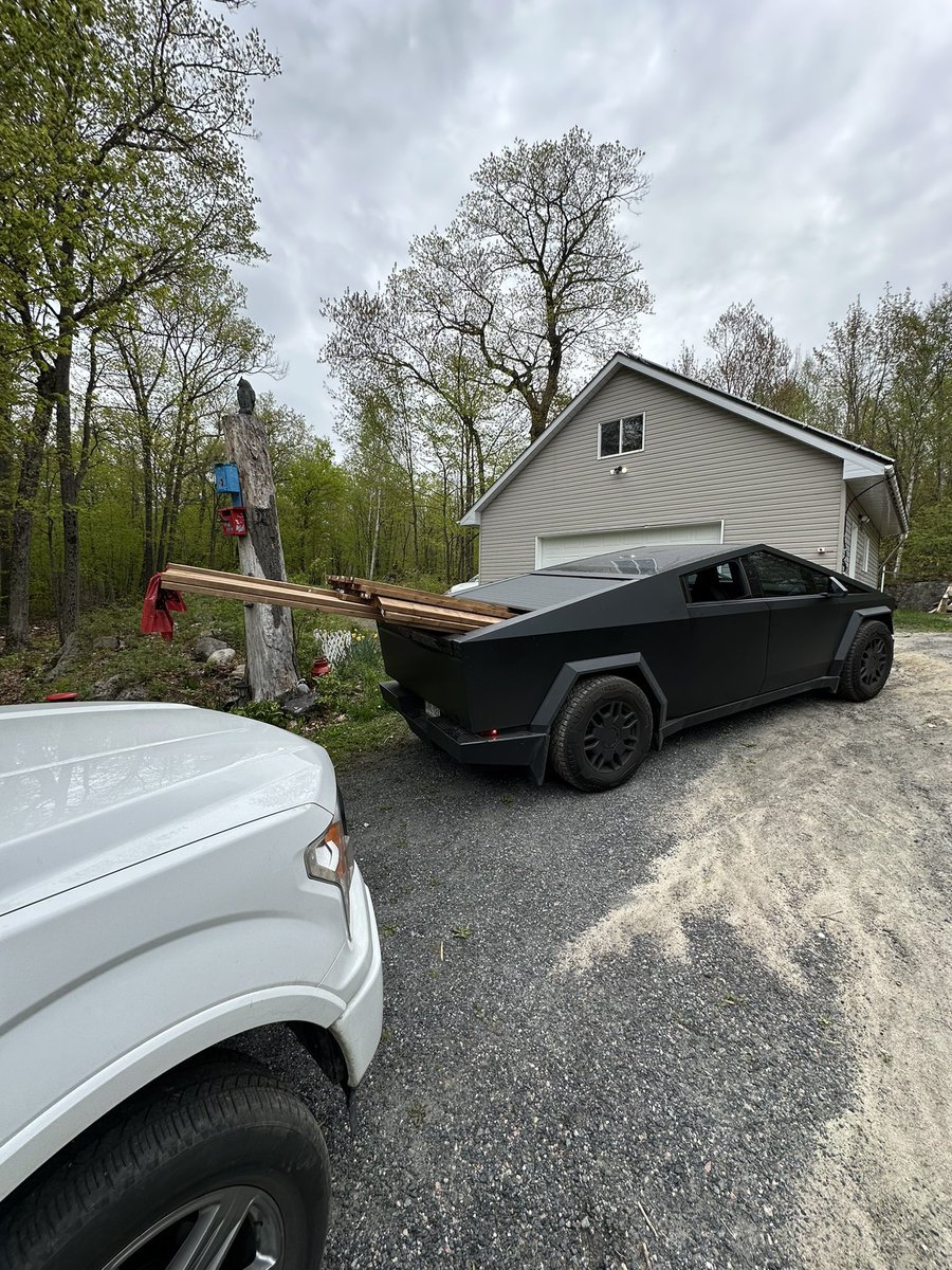 Yev_K's tweet photo. Real truck work done by cybertruck. Can’t even feel any weight, no squat. Tonneau helps keep everything in place. And then back home to charge from sun ☀️ Love my cybertruck ❤️ https://t.co/uqGKyDqMQp