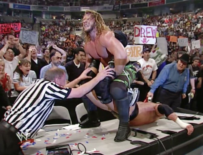 SixtyMinuteDan's tweet photo. They did a callback to 25 years ago (May 21, 2001) when Jericho put HHH in the walls of jericho on the announce table after the torn quad in San Jose.  @davemeltzerWON  @bryanalvarez https://t.co/XbOEONiWJJ
