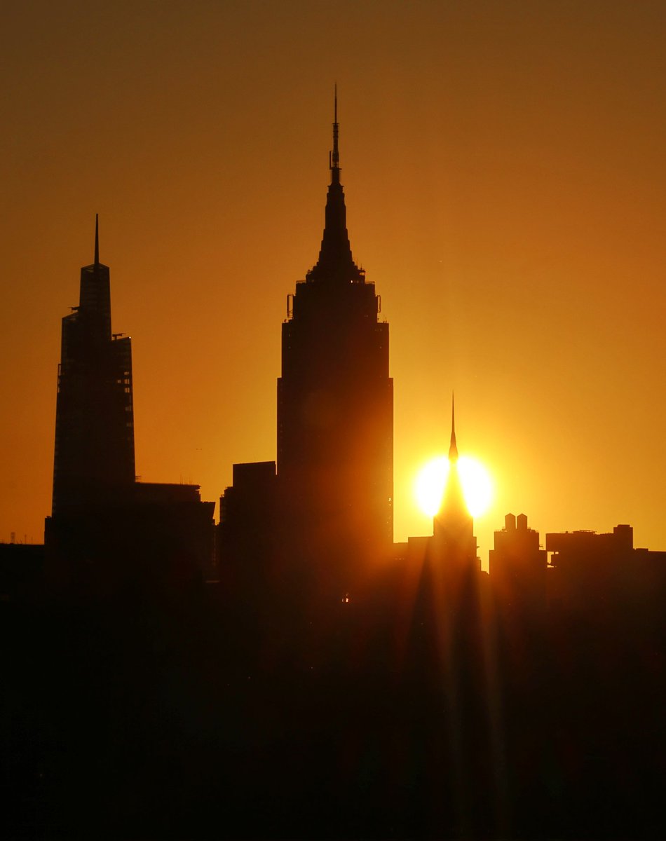 GaryHershorn's tweet photo. The sun rises behind the Chrysler Building which turned 96-years-old yesterday, the Empire State Building and One Vanderbilt in New York City, Thursday morning #newyorkcity #nyc #newyork #sunrise @empirestatebldg #chryslernyc https://t.co/RUEHLf1bJZ