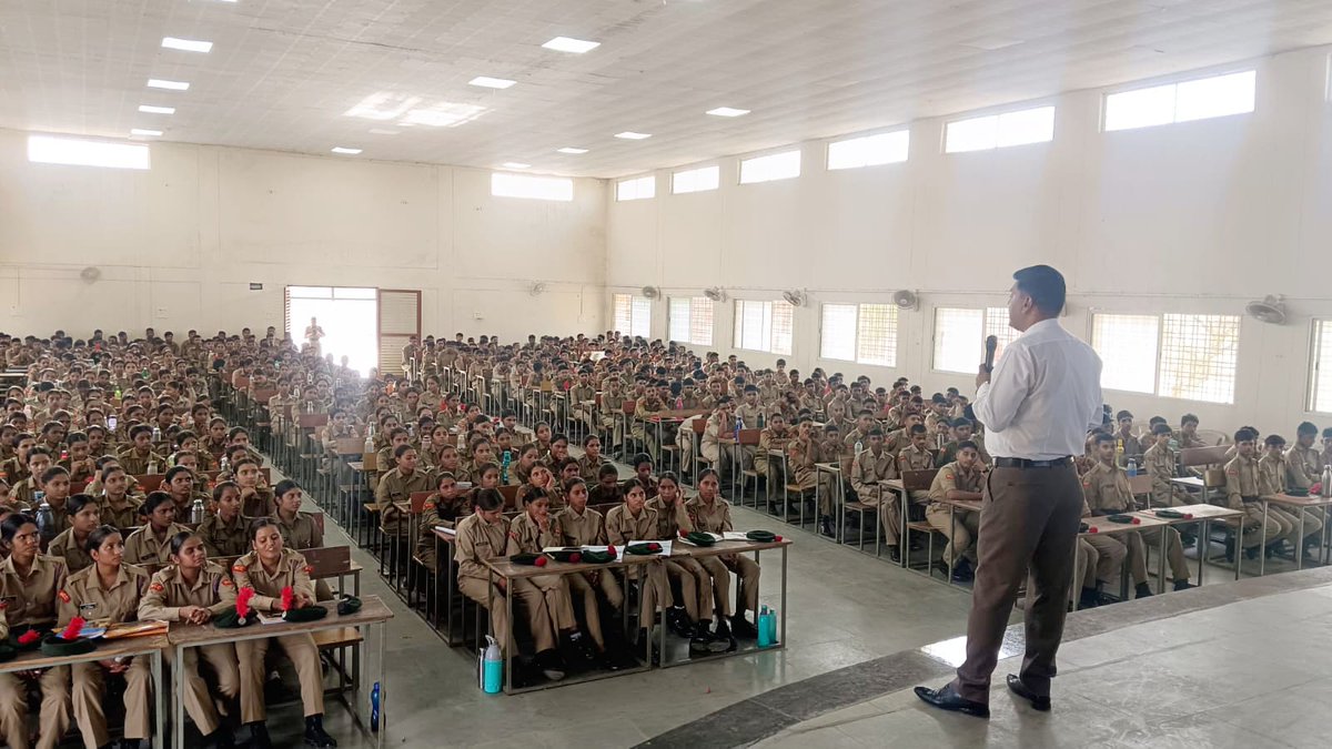 NCIBHQ's tweet photo. एनसीआईबी मध्यप्रदेश एवं 21 एमपी एनसीसी बटालियन द्वारा “सायबर अपराध एवं बचाव” विषय पर विशेष जागरूकता व्याख्यान आयोजित

दिनांक 25 मई 2026 को 21 एमपी एनसीसी बटालियन, रतलाम द्वारा आयोजित “संयुक्त वार्षिक प्रशिक्षण शिविर” के अंतर्गत शासकीय एकलव्य मॉडल आवासीय विद्यालय, सेलाना में “सायबर अपराध एवं उससे बचाव के तरीके” विषय पर एक विशेष जागरूकता व्याख्यान का आयोजन किया गया। कार्यक्रम में एनसीआईबी मध्यप्रदेश इकाई की महत्वपूर्ण सहभागिता रही।

उक्त कार्यक्रम हेतु 21 एमपी एनसीसी बटालियन, रतलाम द्वारा जारी पत्र क्रमांक 21MP/110/प्रशिक्षण दिनांक 13 मई 2026 के माध्यम से एनसीआईबी मध्यप्रदेश इकाई के स्टेट डायरेक्टर श्री राजेश सुराणा को मुख्य वक्ता के रूप में आमंत्रित किया गया था।

यह संयुक्त वार्षिक प्रशिक्षण शिविर दिनांक 24 मई 2026 से 02 जून 2026 तक आयोजित किया जा रहा है, जिसमें रतलाम, मंदसौर, जावरा, नागदा, अलीराजपुर, थांदला, सेलाना, पेटलावद, कुक्षी एवं इंदौर क्षेत्र से आए लगभग 550 एनसीसी कैडेट्स सहभागिता कर सैन्य प्रशिक्षण एवं व्यक्तित्व विकास प्रशिक्षण प्राप्त कर रहे हैं। कार्यक्रम में सैन्य अधिकारियों, एनसीसी अधिकारियों एवं कैडेट्स की विशेष उपस्थिति रही।

अपने प्रेरणादायी व्याख्यान में श्री राजेश सुराणा ने वर्तमान समय में तेजी से बढ़ रहे साइबर अपराधों एवं डिजिटल सुरक्षा के महत्व पर विस्तारपूर्वक प्रकाश डाला। उन्होंने कैडेट्स को ऑनलाइन फ्रॉड, सोशल मीडिया अपराध, फर्जी लिंक, OTP धोखाधड़ी, मोबाइल हैकिंग, साइबर ठगी एवं डिजिटल सुरक्षा से संबंधित महत्वपूर्ण जानकारियाँ प्रदान कीं। साथ ही सुरक्षित इंटरनेट उपयोग, सोशल मीडिया के जिम्मेदारीपूर्ण उपयोग एवं साइबर अपराध होने की स्थिति में शिकायत दर्ज कराने की प्रक्रिया के बारे में व्यावहारिक उदाहरणों सहित विस्तार से समझाया।

कार्यक्रम के दौरान कैडेट्स को डिजिटल जागरूकता, साइबर सुरक्षा एवं नशामुक्ति की शपथ दिलाई गई तथा उन्हें इंटरनेट एवं सोशल मीडिया का सकारात्मक एवं जिम्मेदारीपूर्ण उपयोग करने हेतु प्रेरित किया गया। उपस्थित कैडेट्स एवं अधिकारियों द्वारा विषय से संबंधित विभिन्न प्रश्न पूछे गए, जिनका श्री सुराणा ने सरल एवं व्यावहारिक उदाहरणों के माध्यम से समाधान प्रस्तुत किया।

कार्यक्रम के समापन अवसर पर केम्प इंचार्ज सुबेदार मेजर कालीचरण एवं बटालियन अधिकारियों द्वारा व्याख्यान की सराहना करते हुए श्री राजेश सुराणा का आभार व्यक्त किया गया तथा स्मृति चिन्ह भेंट कर सम्मानित किया गया।

यह आयोजन कैडेट्स में साइबर सुरक्षा के प्रति जागरूकता बढ़ाने, डिजिटल अपराधों से बचाव हेतु सजगता विकसित करने एवं जिम्मेदार डिजिटल नागरिक बनने की दिशा में अत्यंत प्रेरणादायी एवं उपयोगी सिद्ध हुआ।
@NCIBMP @Cyberdost @DGP_MP @PMOIndia @rashtrapatibhvn