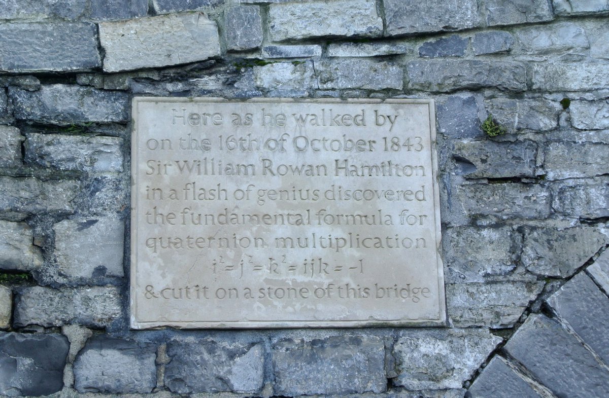PhysInHistory's tweet photo. On 16 October 1843, William Rowan Hamilton was walking with his wife along the Royal Canal in Dublin toward a meeting of the Royal Irish Academy. For years he had been trying to extend complex numbers to three dimensions, and his sons had taken to teasing him at breakfast: "Well, Papa, can you multiply triples?" — to which he always had to answer no.

As he crossed Brougham Bridge (now Broom Bridge), it suddenly came to him that the trick was to use four dimensions, not three, and to abandon commutativity. He carved the fundamental rules into the stone of the bridge: i² = j² = k² = ijk = −1. The original scratching is long gone, but a stone plaque on the bridge commemorates it, and mathematicians make an annual pilgrimage there on the anniversary — the Hamilton Walk, founded in 1990.