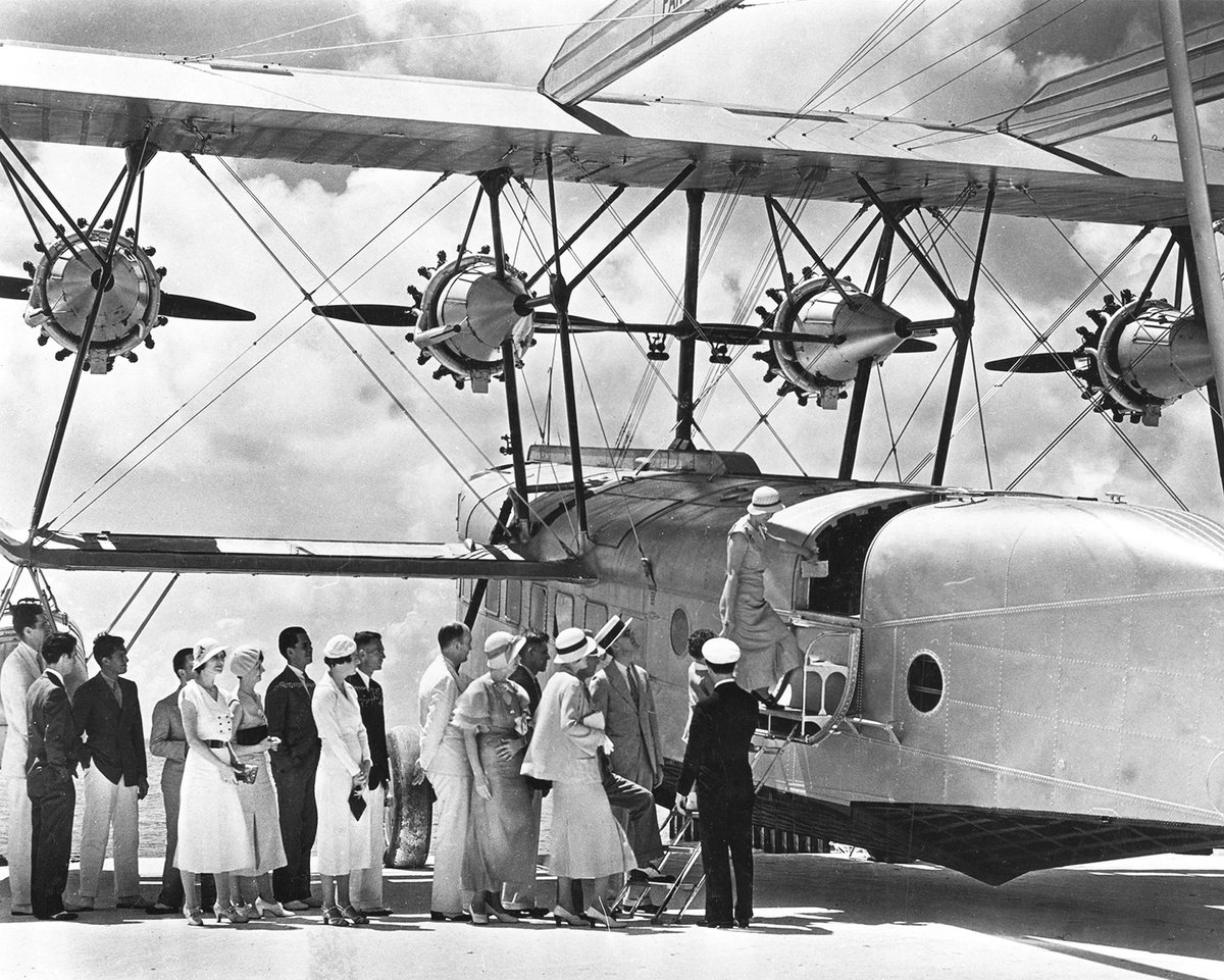 pastarchive's tweet photo. Passengers board a new upgraded Pan American Sikorsky S-40 plane. 1932. https://t.co/24IY8ubeOD