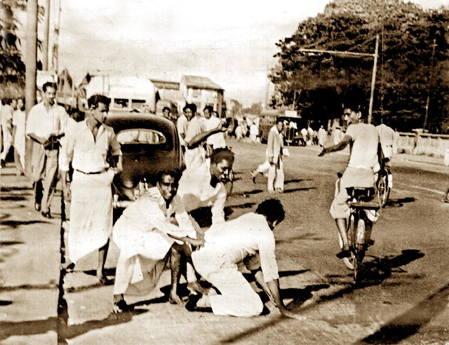 TamilGuardian's tweet photo. 🪔 Remembering the 1958 pogrom

This week marks 68 years since Sinhala mobs unleashed a wave of anti-Tamil violence across the island, in what became one of the deadliest anti-Tamil pogroms in Sri Lanka's post-independence history.

Beginning on 22 May 1958 and continuing into June, the violence left hundreds of Tamils dead, thousands displaced and entire communities traumatised. 

Estimates place the death toll at between 300 and 1,500 Tamils, whilst countless others were injured. Tamil homes, businesses and places of worship were looted and burned, women were subjected to sexual violence and thousands were forced to flee as refugees.

The pogrom erupted just two years after the island’s first ethnic based pogrom against Tamils in 1956 and followed escalating tensions surrounding the Sinhala Only Act, which had marginalised the Tamil language and intensified Sinhala-Buddhist nationalism across the island.

📸 A Sinhalese mob beats a Tamil passenger after pulling him out of his car, 1958.