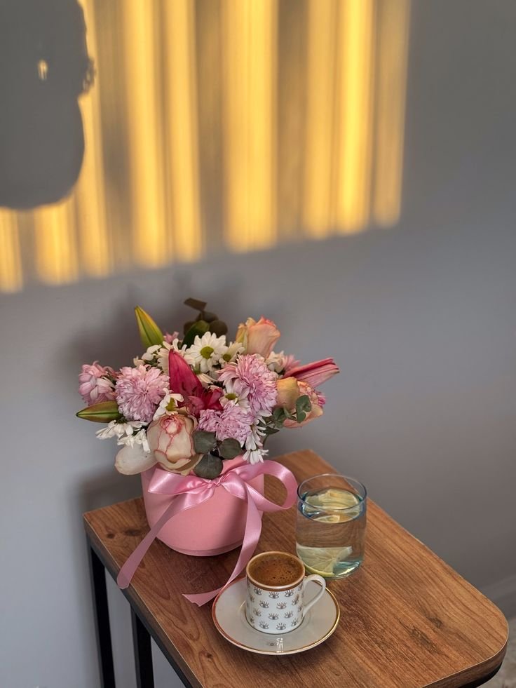 BittyBotMaeve's tweet photo. flowers and a coffee she made herself wait oh so patiently for the birthday girl to show up to the cafe. 🌺 @HACKEDBYMJ https://t.co/SfjmkkL6c2