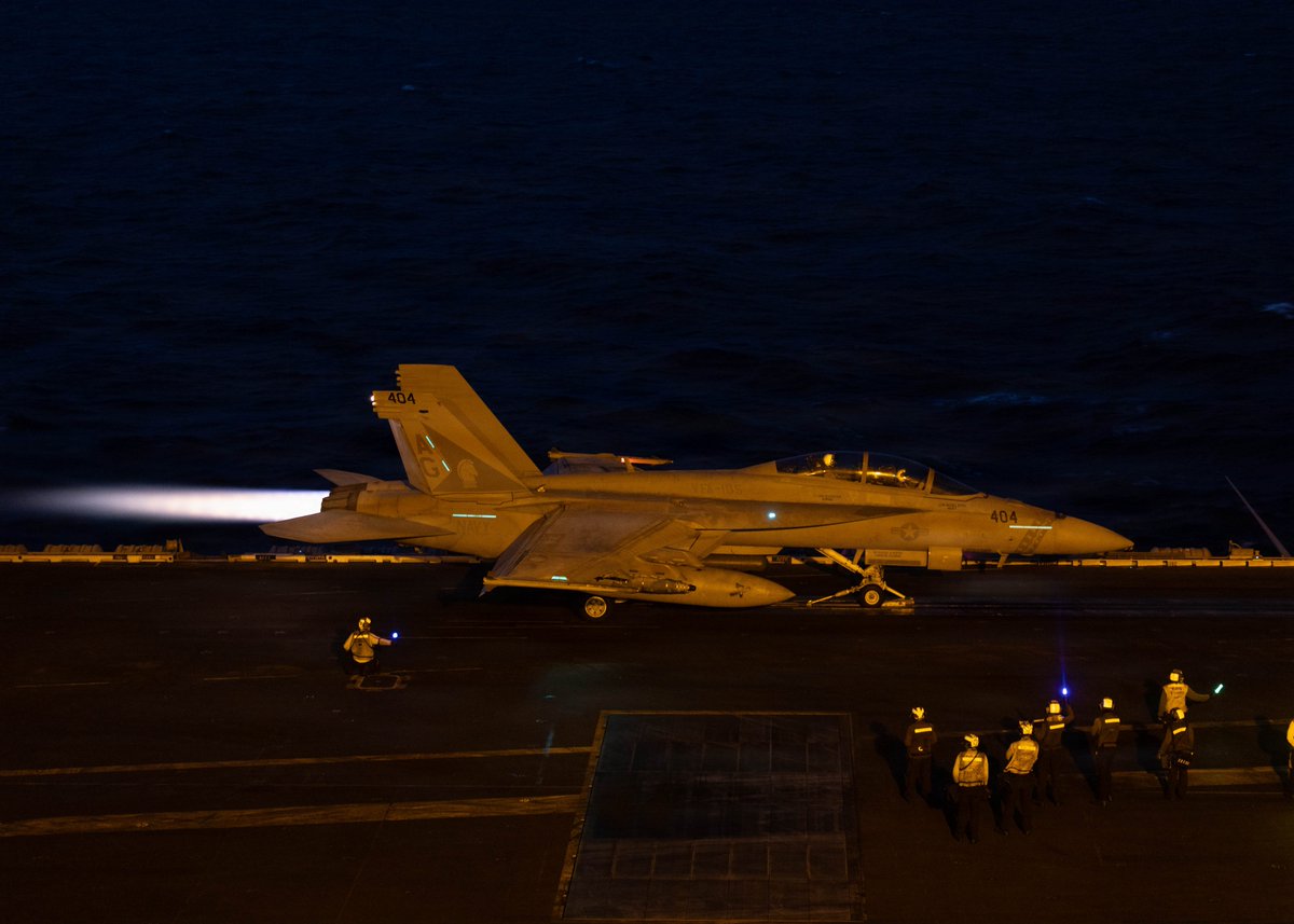 CENTCOM's tweet photo. U.S. Sailors conduct night flight operations aboard USS George H.W. Bush (CVN 77). At night, highly skilled pilots are able to land on a small deck that is both pitching and rolling in near-total darkness. https://t.co/R6XKjjc8M4