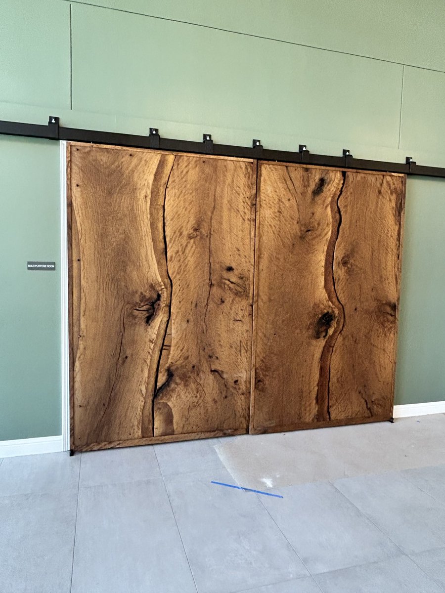 MetroBuilt's tweet photo. At Morningside Ministries Menger Springs, a custom wood door was made from a tree removed during construction. This transformation adds warmth and character to the retirement community designed for comfort and connection.

#METROBuilt #BuildingSomethingBetter https://t.co/SGp0CojSnQ