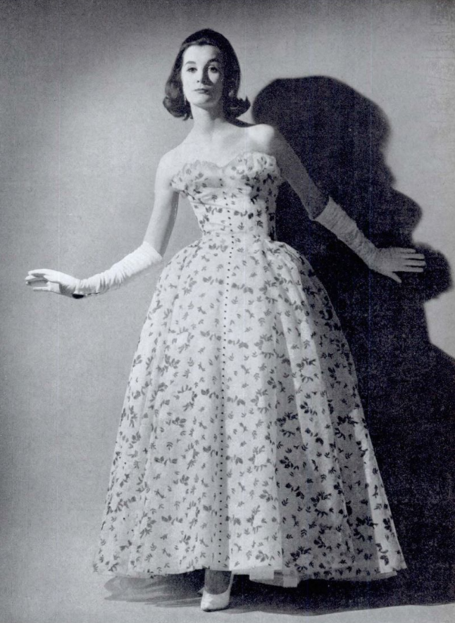 BNArchive's tweet photo. We're completely in love with this full-skirted Chantilly lace dress, with a pattern of white roses and black leaves. The bodice is edged with white net ruffles, and it is designed by Angele Delanghe - from Country Life, 25 May 1961 https://t.co/mD5F64MS4k #SaturdayStyle https://t.co/a6AXLHC8p9
