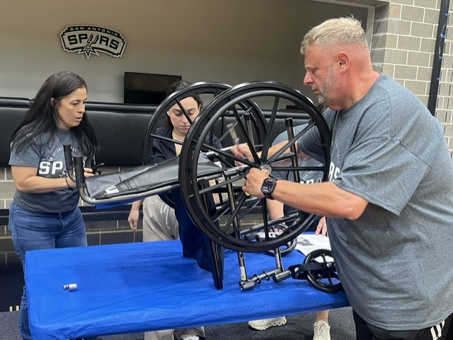 ProjectMENDSA's tweet photo. Like the @officialSpurs chasing a championship, their Season Ticket Members brought teamwork &amp; competitive spirit to our Make a Chair event! Together, they built wheelchairs for neighbors in need - proving true champions make an impact on and off the court. 🖤🏀
#CommunityImpact https://t.co/aUshJW3Xe1