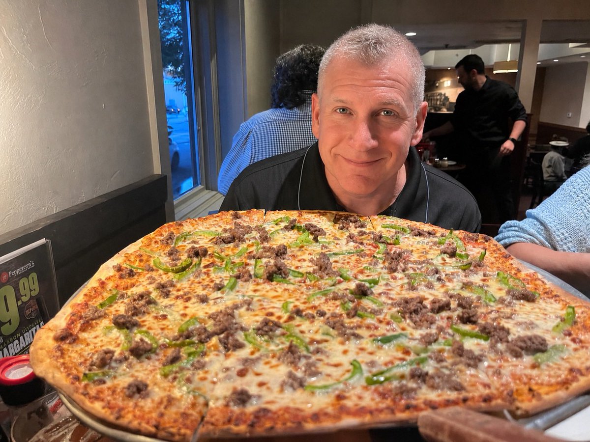 danpnut's tweet photo. My pizza is bigger than me! https://t.co/xsyYCngqjy