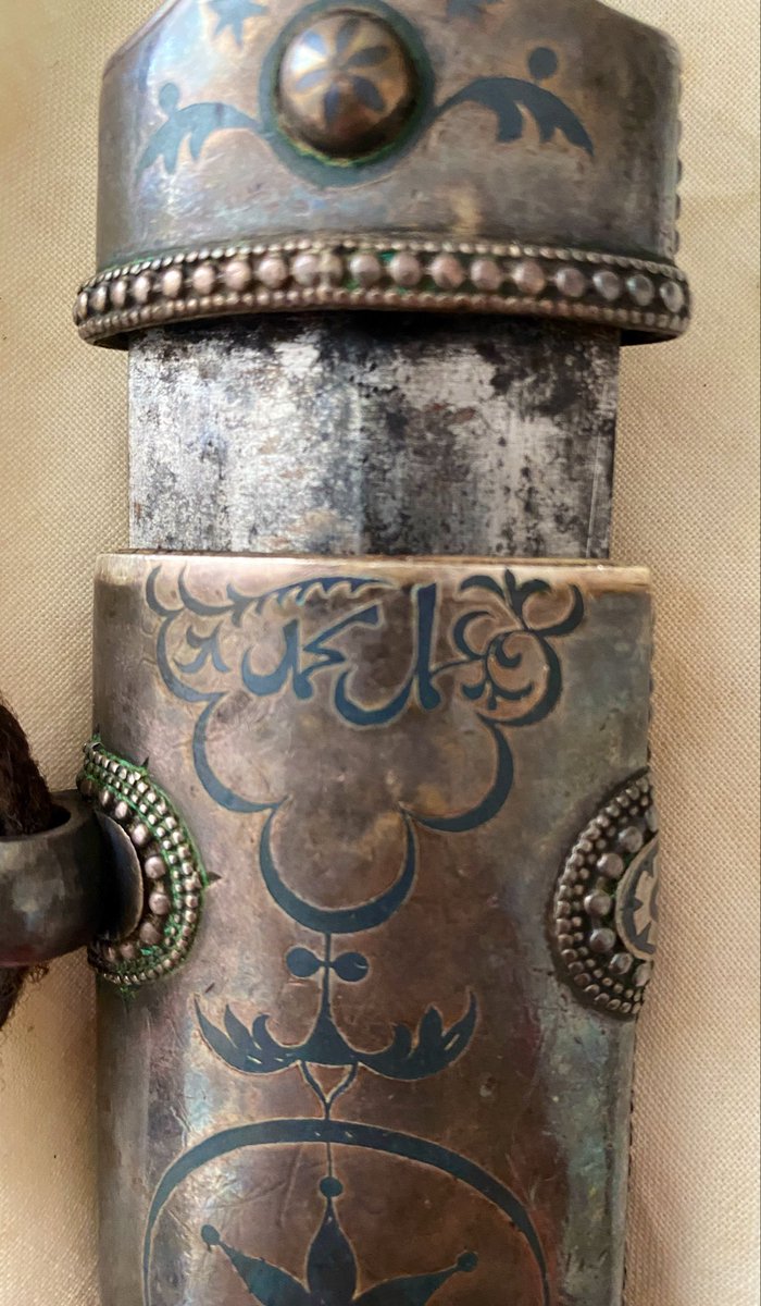 TselmesBi's tweet photo. The bladesmith's mark on my own kindjal, passed down to me from my grandfather, and to him from his ancestors. I estimate it to be about 180-200 years old. It is a Dagestani piece with an unfullered steel blade and silver niello work. There is no date, but the name can be clearly read as عمل محمد meaning the work of Muhammad.