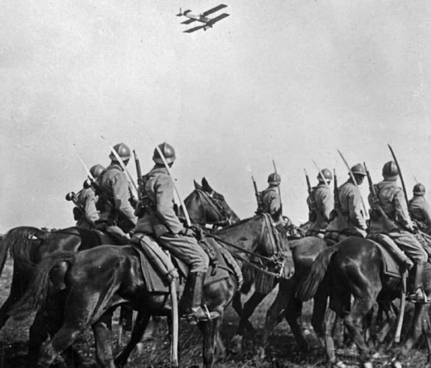 historyinmemes's tweet photo. French cavalrymen pause to watch an aircraft pass overhead, 1916.

This iconic photograph captures a pivotal moment in military history, symbolizing the transition from the old world to the new. Taken during World War I, between 1916 and 1917, it shows French cavalrymen halted on a dusty road, gazing skyward as an airplane passes overhead.

The scene reflects a dramatic shift on the battlefield. For centuries, cavalry had been the eyes and ears of an army, responsible for reconnaissance, communication, and scouting. Yet the realities of trench warfare, machine guns, and modern artillery were rapidly rendering horse-mounted troops obsolete. Aircraft were beginning to assume many of the cavalry’s traditional roles, from intelligence gathering to artillery observation, marking the emergence of modern mechanized warfare and a new era in military history.