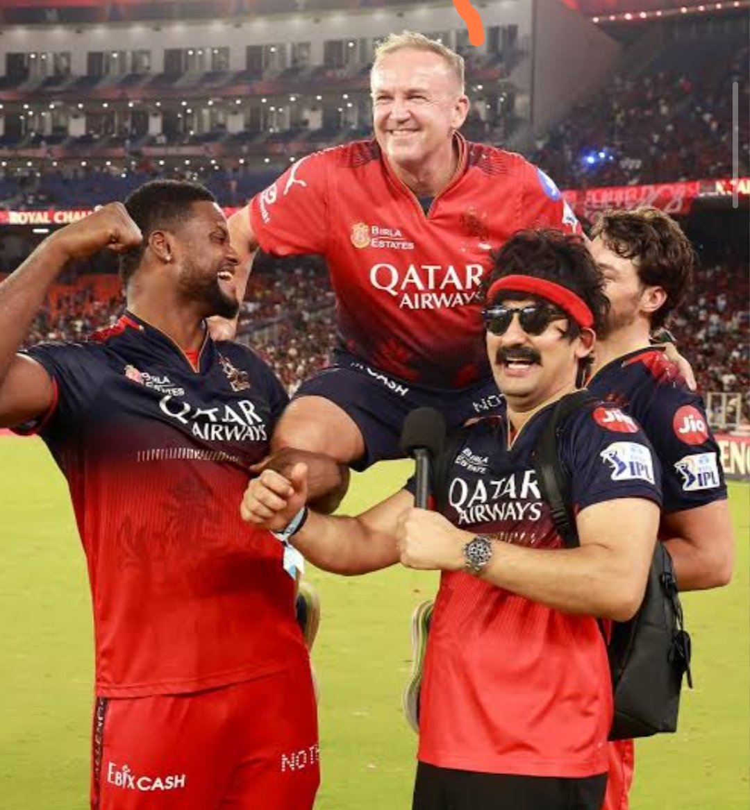 CourageousRo's tweet photo. Andy flower literally said this on Virat Kohli's face 😭🔥

Harsha bhogle :  How's you feeling after winning two back to back trophies

He said "Yeah really feeling great harsha, after being trophyless for 18 years and choking on every big moment we are finally winning some now, This is a new team, Credit also goes to Rajat Patidar the way he handled this team".