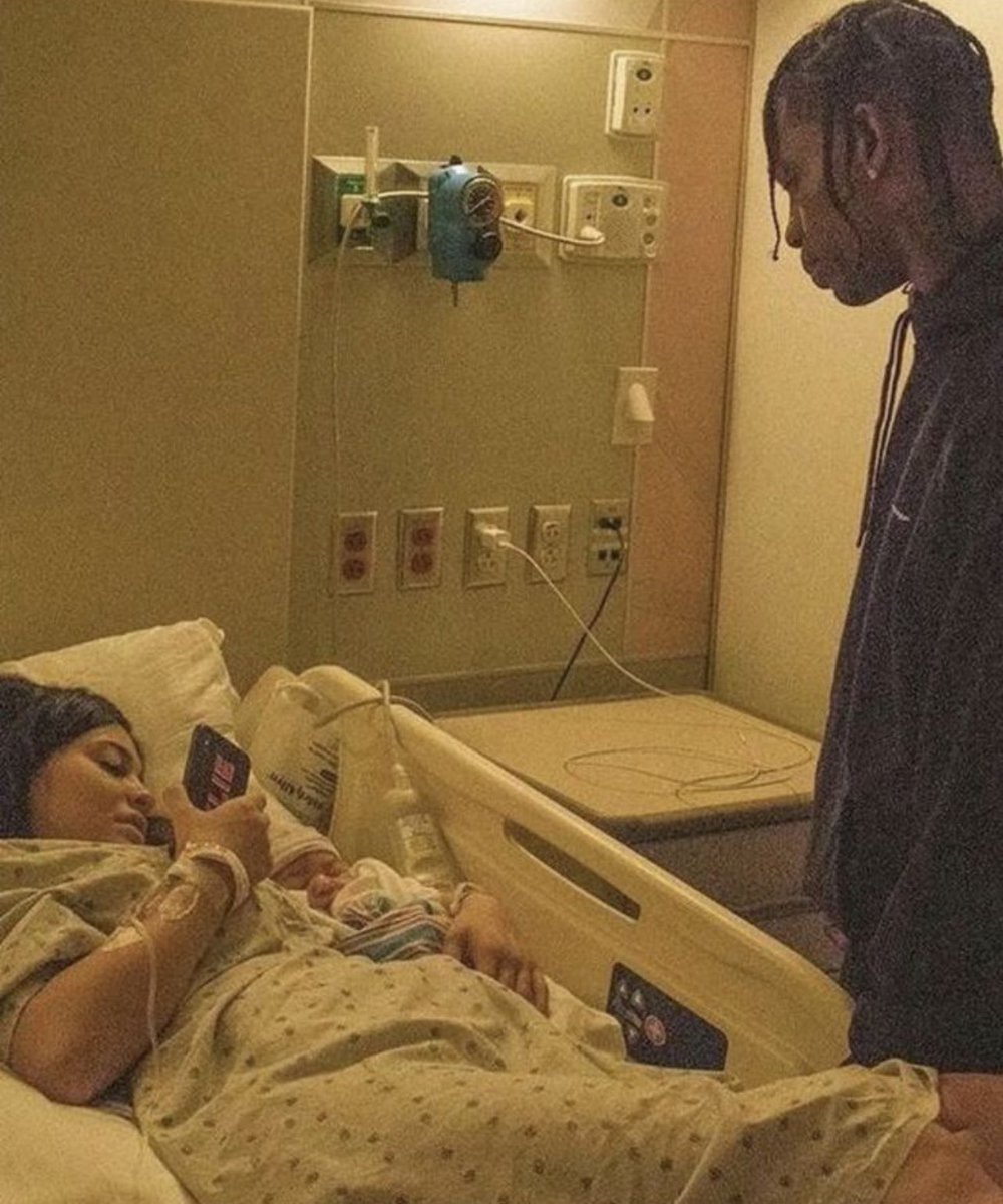 Hisomtheboat's tweet photo. In 2017, 19 year old Kylie Jenner got pregnant by 26 year old Travis Scott. Travis was shocked and initially struggled to believe her when she told him she was pregnant after just a few months of dating. He took her to the hospital for a test. When the results confirmed she was telling the truth, he reportedly wanted her to terminate the pregnancy to protect his reputation. He was also concerned about how Kylie’s family particularly her father, who was perceived as racist at the time would react to her being so young and pregnant by him.
Kylie disagreed, leading to a fight. Travis then distanced himself to focus on his music.

On February 1, 2018, Kylie gave birth to their first daughter, Stormi. Travis received a call that his girlfriend was in labor, rushed to the hospital, and arrived after the baby had already been born. This is when the iconic photo of him staring at Kylie and Stormi was taken.