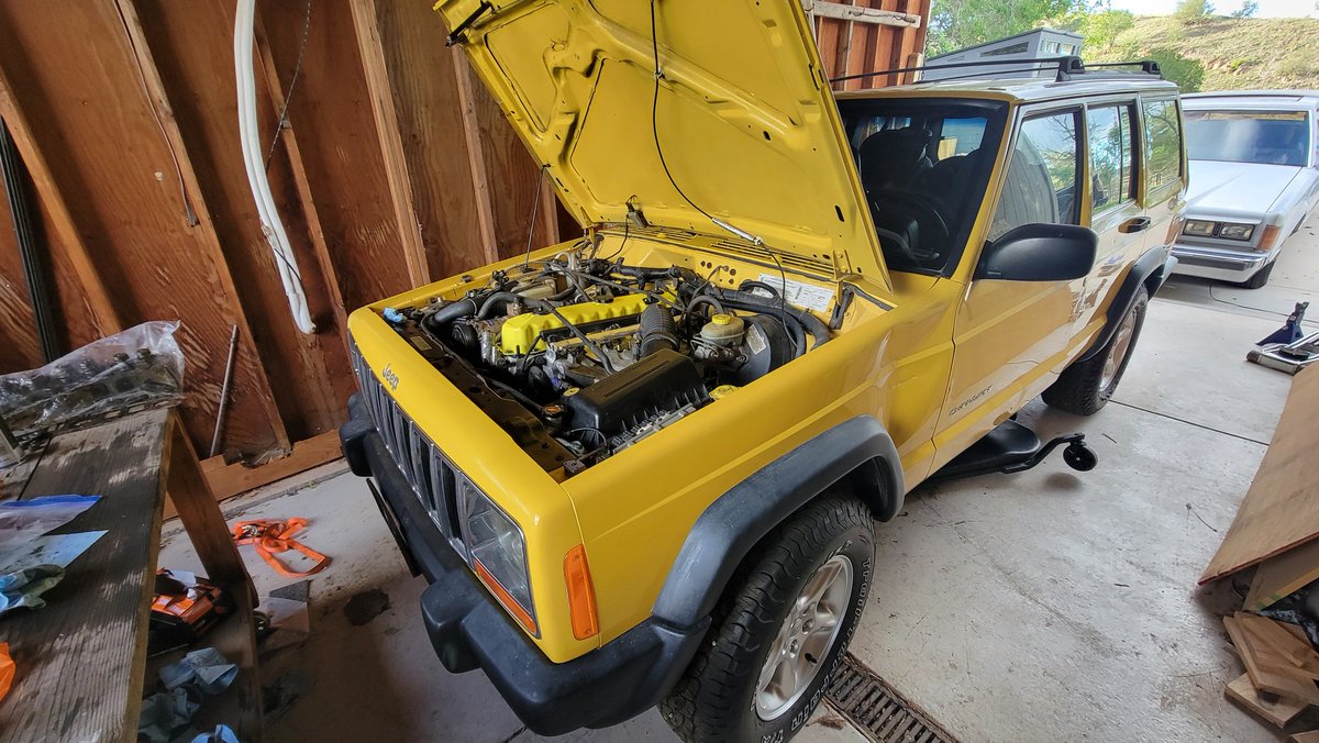 jeriley's tweet photo. So close this weekend. Its on the ground but due to 2 problems that I created... I didnt get to crank it over.

Replaced a 2nd stuck lifter, new one would NOT go home. 4. hours. wasted.

and I MIGHT....MIGHT... have installed some exhaust hardware upside down. 2 hours wasted.

It needs the oil pan bolts done up, a bunch of things up top torqued to spec ... I'm so so close. And I still love that yellow valve cover.