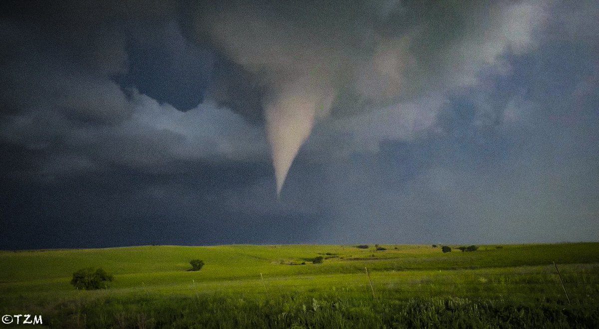 PappenheimWx's tweet photo. Last night was one of those nights that makes you wonder if it was even real. I’ve dreamed of witnessing a tornado in the Kansas Flint Hills since I started this journey, and it finally happened. One perfectly timed exposure, an off-frame lightning strike illuminating the rolling green hills and a photogenic cone tornado, with no power lines or city lights in sight.

What made it even better was sharing the moment with the handful of familiar faces gathered on the lone gravel road, the same people I seem to run into everywhere from the Outer Banks to the Desert Southwest. Remembering this one for a while!