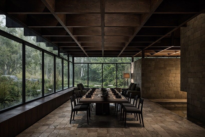 designboom's tweet photo. v taller’s a crafted shelter proposes a forest retreat on japan’s yakushima island for the 2026 not a hotel design competition.

organized around a monolithic stone core and topped with a timber roof that collects rainwater, the project draws from the island’s ancient forests, rock formations, and climate. it received an honorable mention in the competition.
https://t.co/5X3H0B7EtU