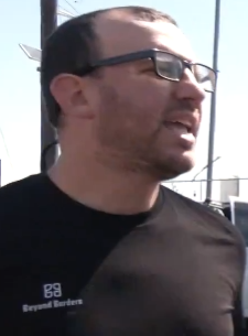 hector_drummond's tweet photo. "Why don't you go back to your country", whispers the sneaky Jew who is there to protest... people being sent back to their countries. He's even wearing a "Beyond Borders" T-shirt. While engaging in "go back to your country" talk.

Everybody favours borders when it suits them. https://t.co/yHMvgkMAma