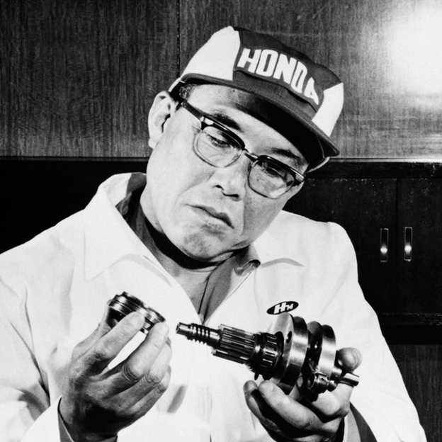 jaynitx's tweet photo. Soichiro Honda's first vehicles were small gasoline engines, originally built to power Japanese army radios, bolted onto bicycle frames.

He wasn't being clever. It was 1946 and most of Japan was in rubble.

Honda was born in 1906 in a small town near Hamamatsu, the son of a blacksmith. He spent his twenties working as a mechanic. In 1936 he started a side business out of a shed, making piston rings at night.

His first big order was for Toyota. The rings failed Toyota's quality test.

He took the rejection apart and went back to school. He was already in his thirties, sitting in metallurgy classes with teenagers, learning what he needed to learn to fix the part. It took him three years to make a piston ring Toyota would accept.

By the time the war came, his company, Tokai Seiki, had grown to about two thousand employees and was supplying piston rings and aircraft parts across the Japanese war industry.

Then everything was taken from him.

The government seized control of the company. Toyota took a forty five percent stake. Honda was demoted from president to senior managing director of his own factory. In 1944, American B-29s bombed his plants twice. In 1945, an earthquake finished the rest.

He sold what was left to Toyota for four hundred and fifty thousand yen, the same company that had rejected his first rings, and walked away with nothing to show for fifteen years of work.

For about a year after the surrender he drank cheap, illegal alcohol and did almost nothing.

Then in 1946, with the country in ruins and gasoline almost impossible to find, he started over. He set up a small shed on the site of the bombed-out factory with twelve other men, and they tried to build whatever they could sell.

They tried rotary weaving machines. No one bought them. They tried frosted glass panels and woven bamboo roof tiles. Neither worked.

Then he spotted a stack of surplus military engines, the small two-stroke generators that had once powered army backpack radios. Nobody else wanted them. He bought up as many as he could and started bolting them onto bicycles with a belt running to the rear wheel.

People needed any transportation they could get. The bikes sold as fast as he could put them together.

In 1948 he turned the shed into a company. He called it Honda Motor Co. He was forty two years old.

Most success stories edit out the part where the protagonist sat in a heap of rubble for a year drinking. That was the most important year. By the time Honda picked himself up, he'd been told no by Toyota, watched his factory get bombed, watched the rest get leveled by an earthquake, lost his company to the government, and tried and failed at three more businesses before he ever bolted a radio motor to a bicycle.

The man who built one of the largest car companies on earth had already lost everything twice before he started.

Honda put it cleanly himself.

"Success represents the one percent of your work which results from the ninety nine percent that is called failure."